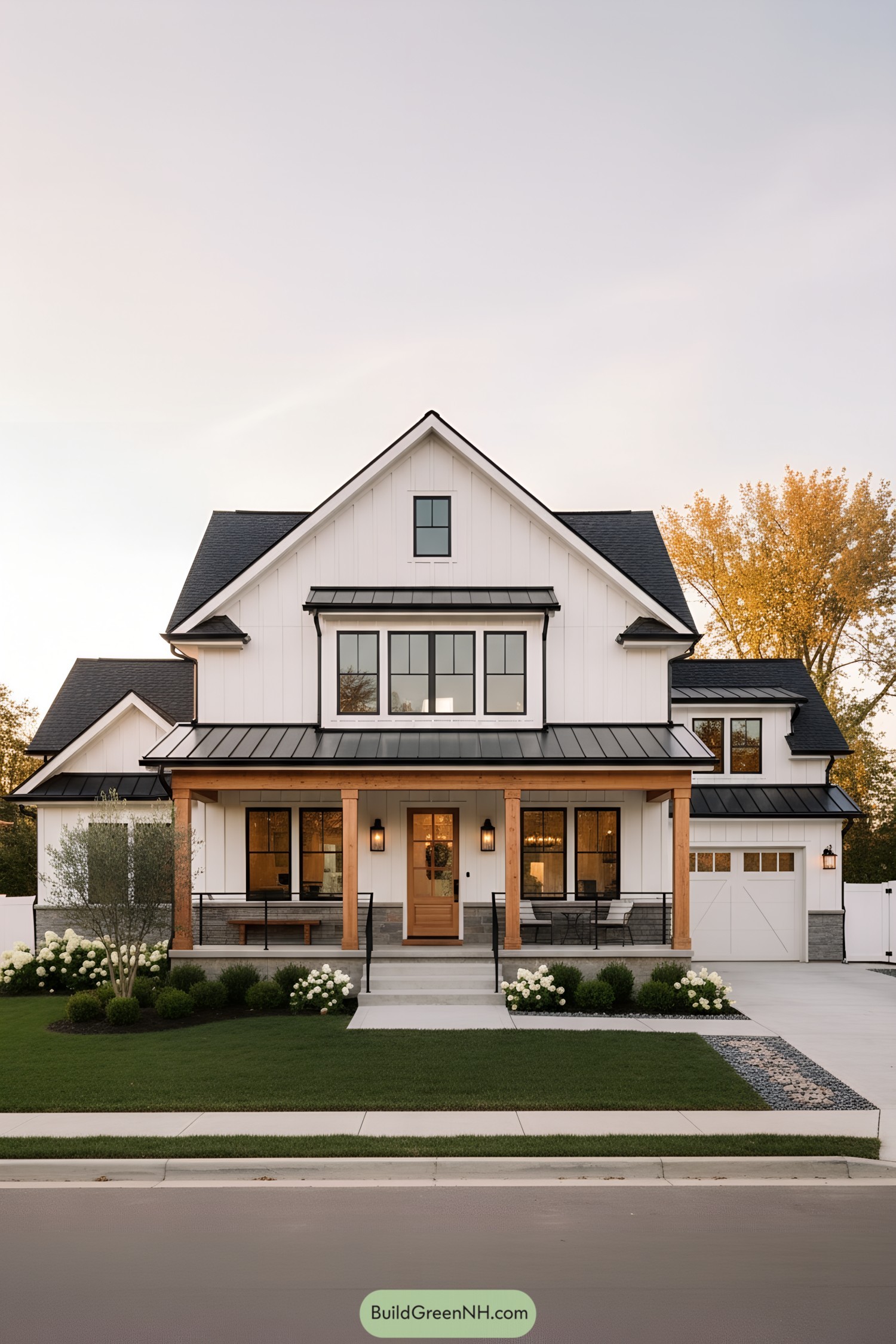 White farmhouse with black metal roof, warm wood accents, and a covered front porch