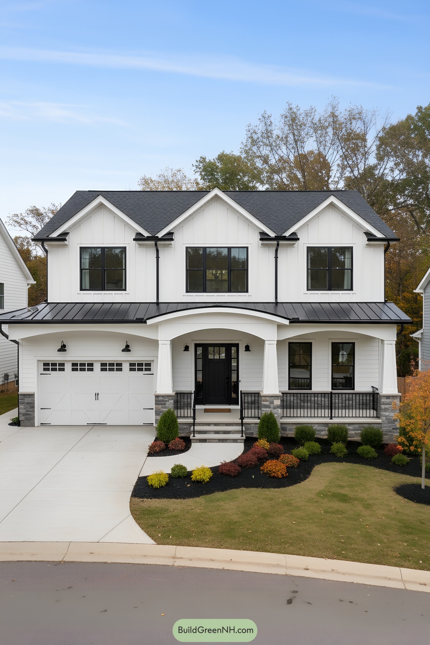White farmhouse with black metal accents and arched porch roof