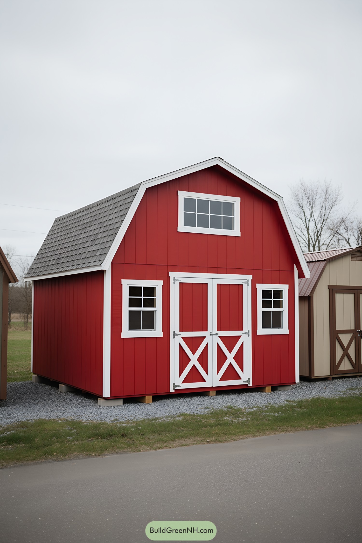 Red mini barn with white trim and crossbuck doors