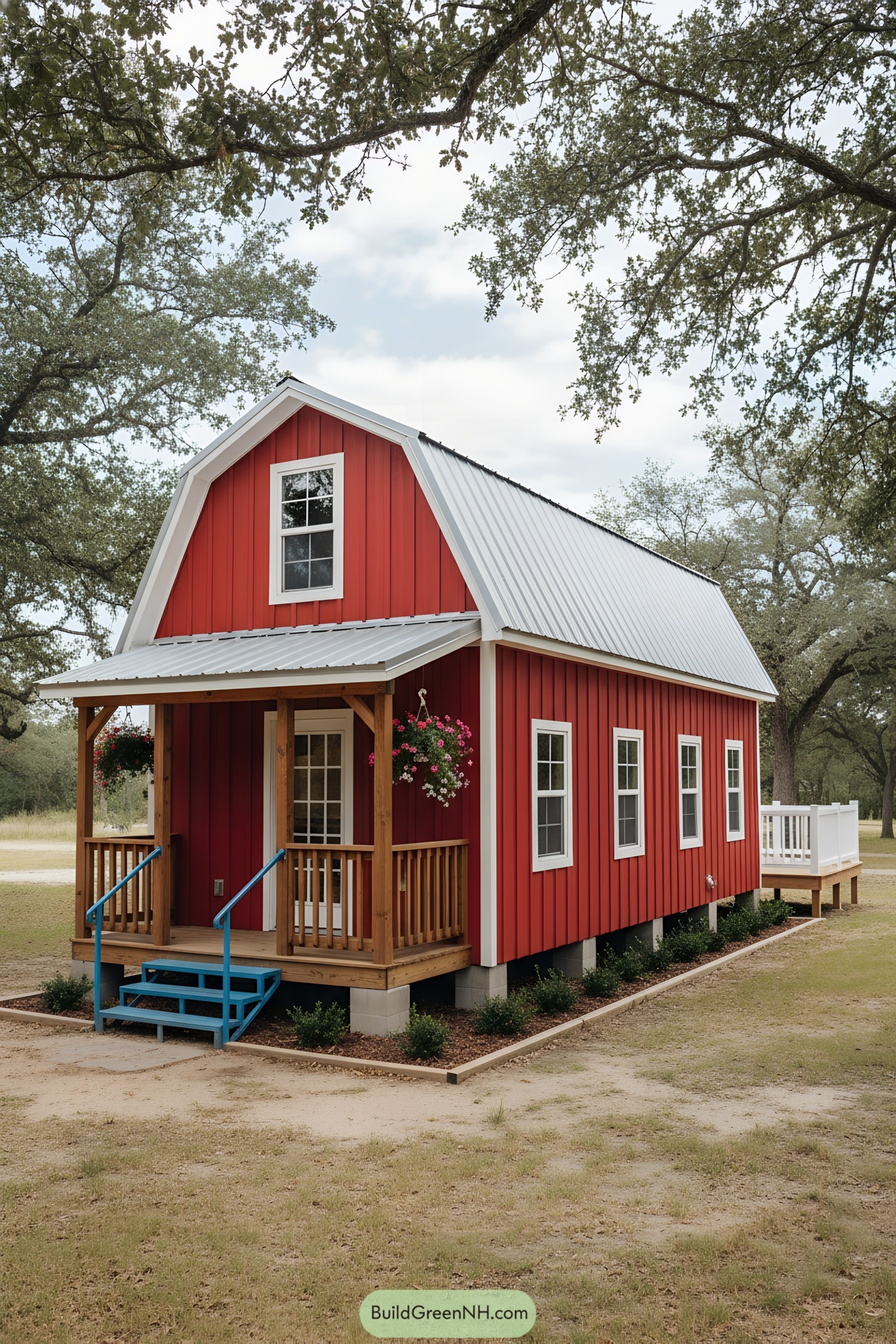 Red tiny barn with white metal roof and small wood porch