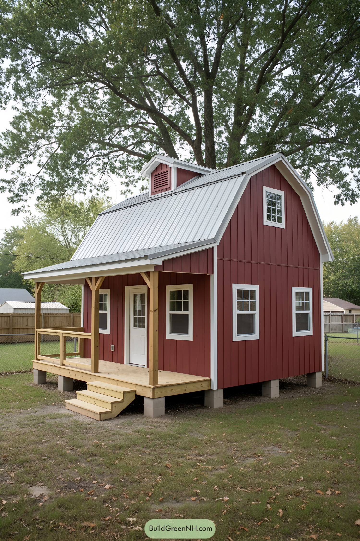 Small red gambrel tiny house with porch