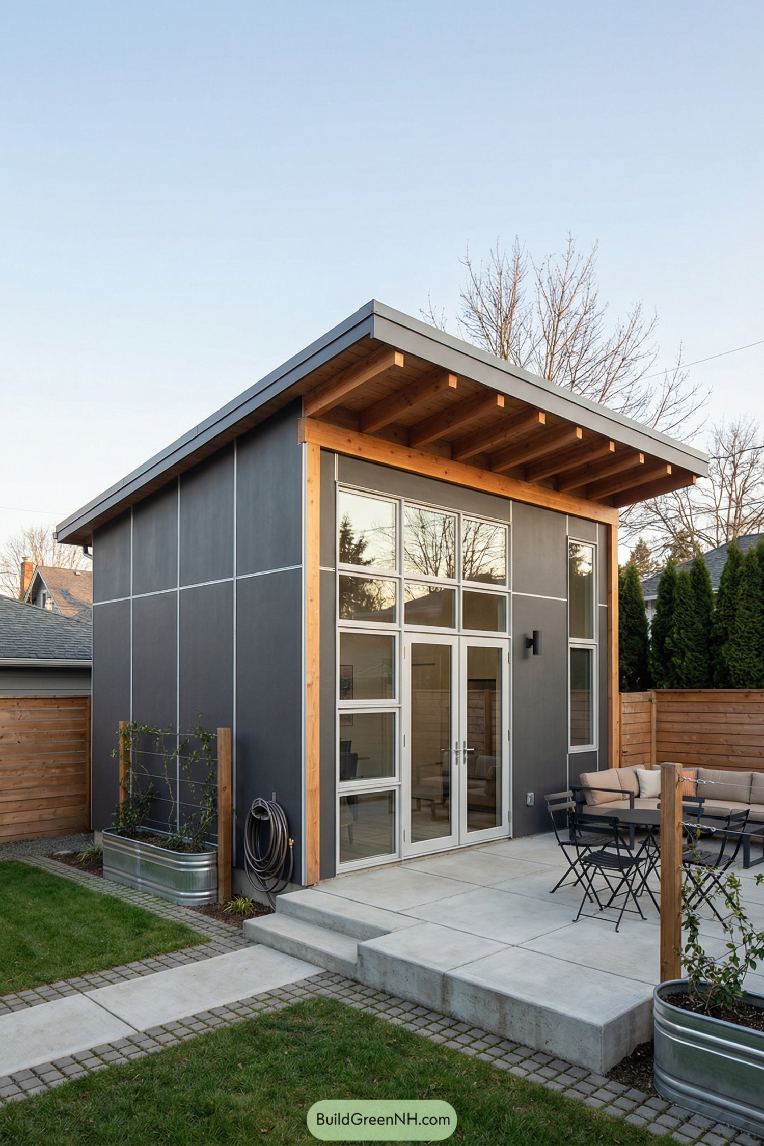 Compact backyard tiny house with tall glazing and angled shed roof