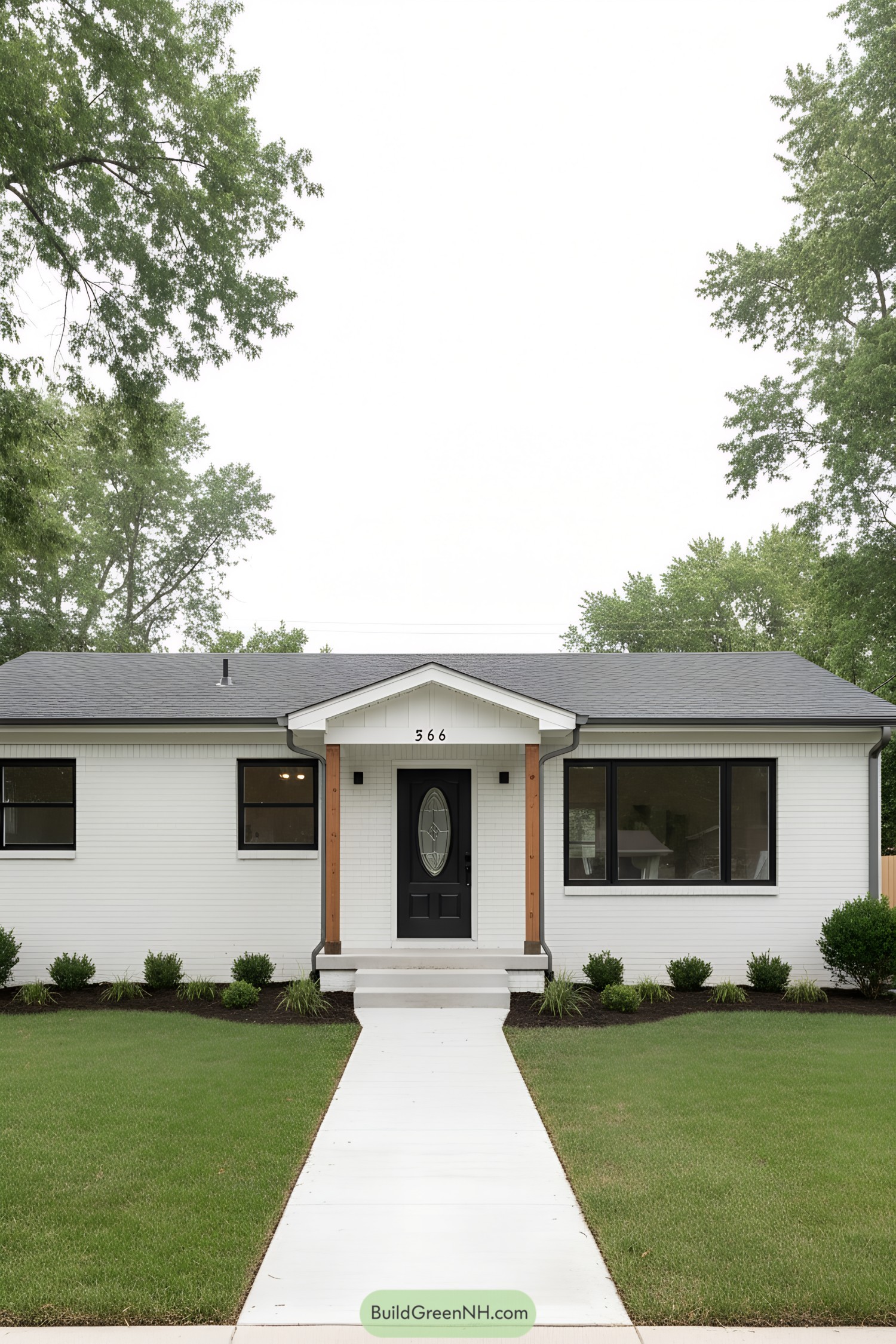 White brick ranch with black trim and small portico