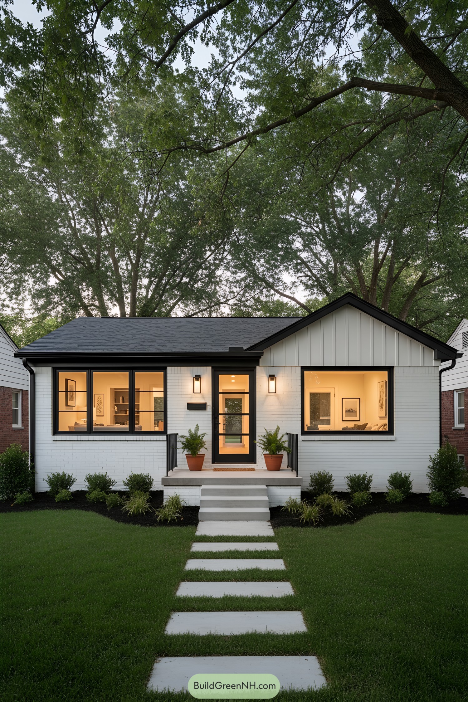 White brick ranch with black trim and warm lighting