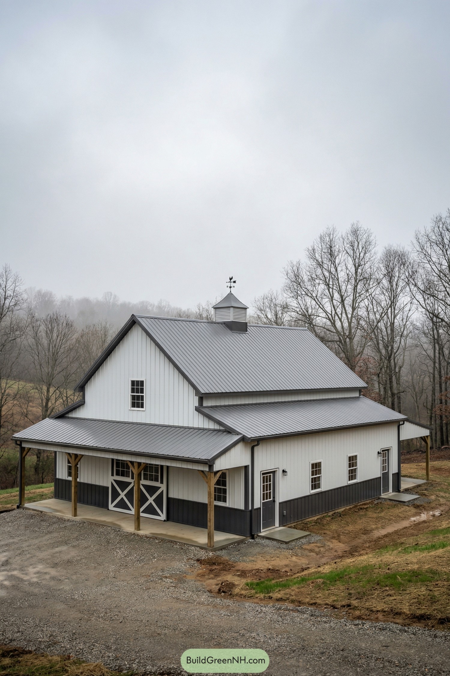 White pole barn with gray metal roof and wraparound shed porch