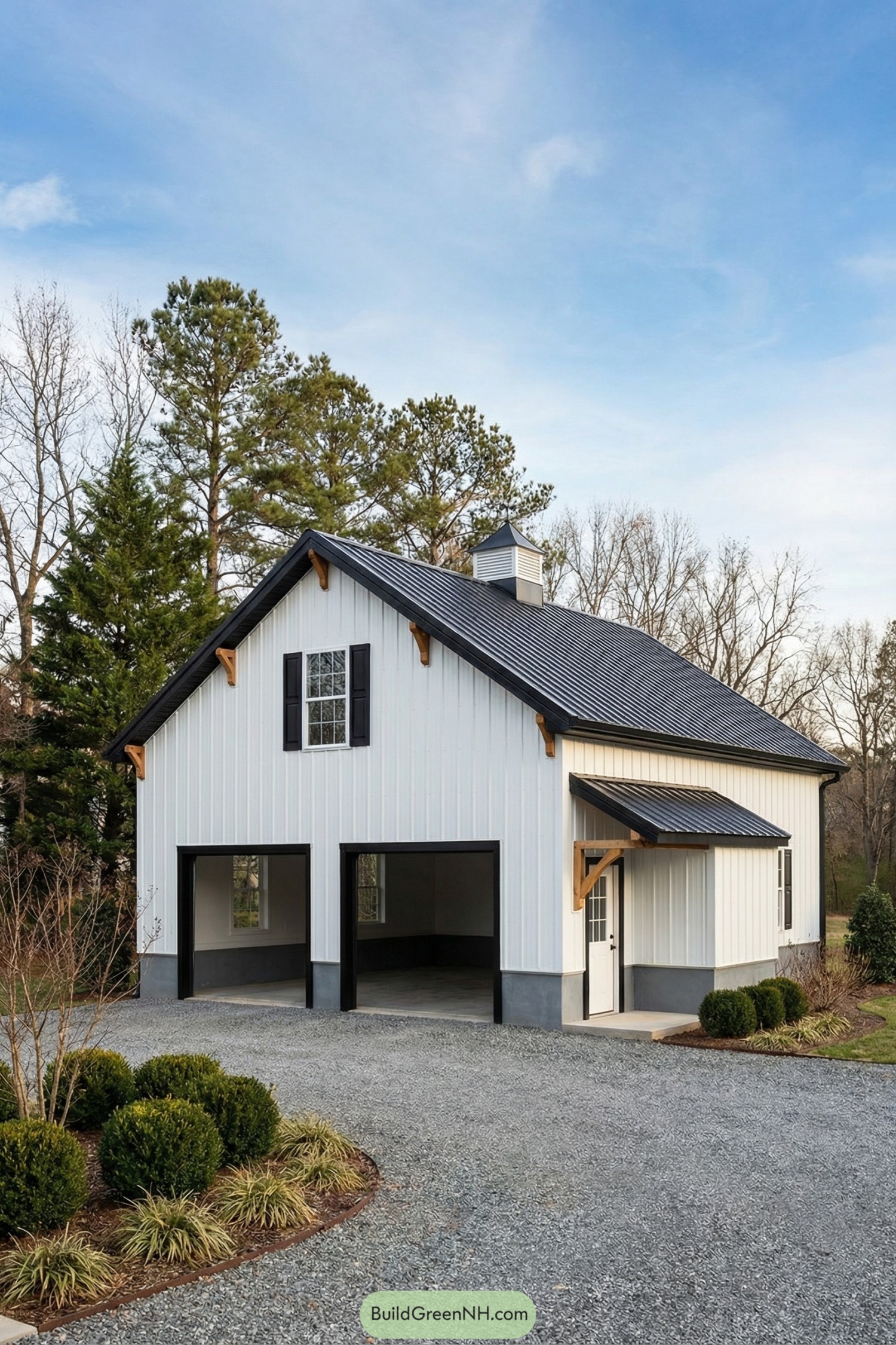 White metal-sided barn with black roof and twin garage bays