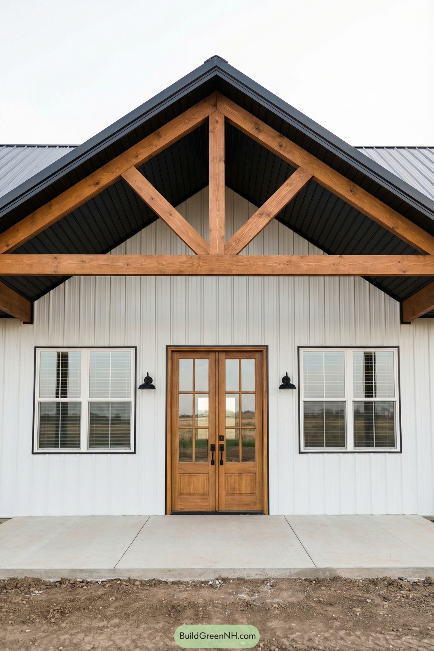 White pole barn facade with timber truss and glass double doors