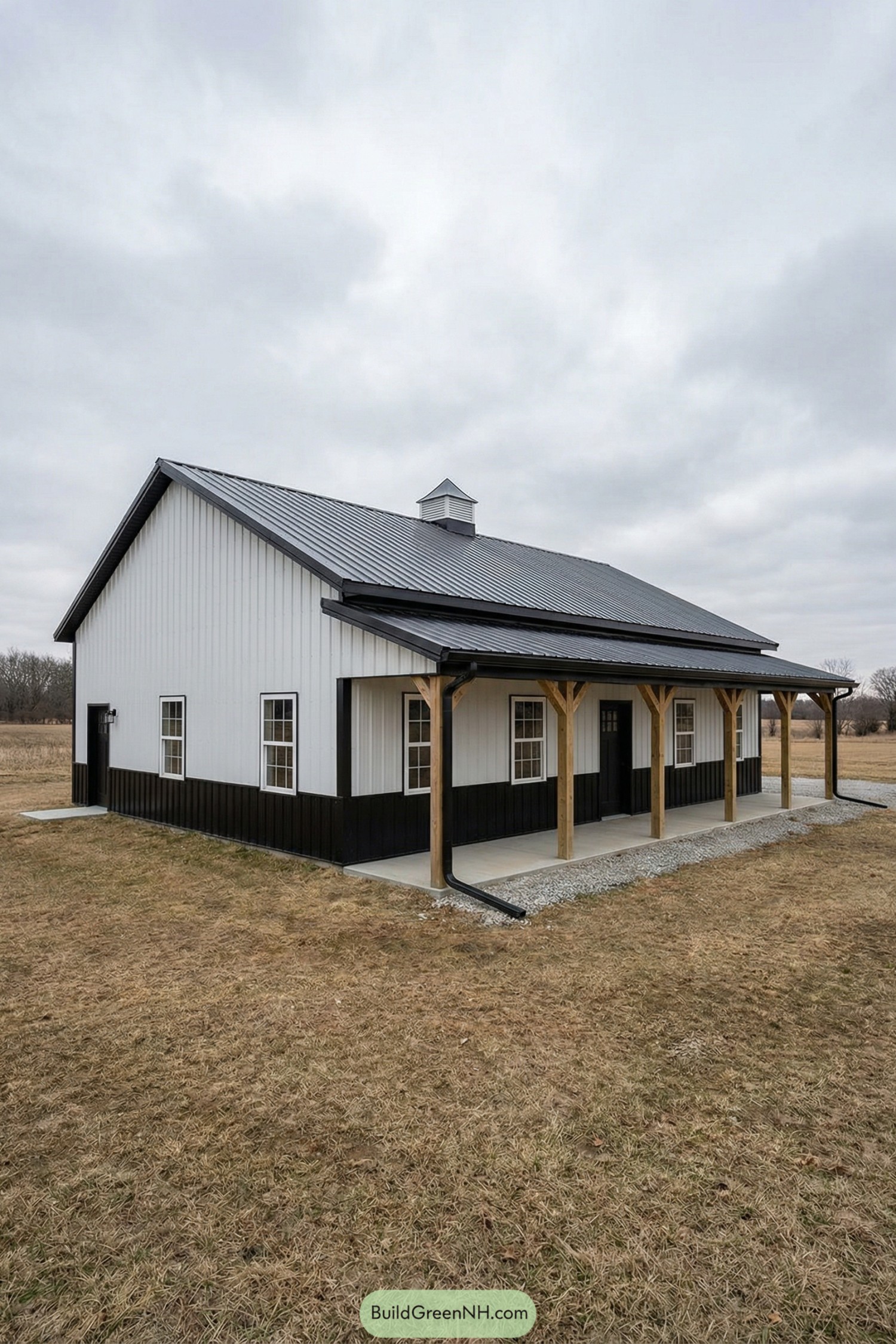 White barn with black wainscot and porch
