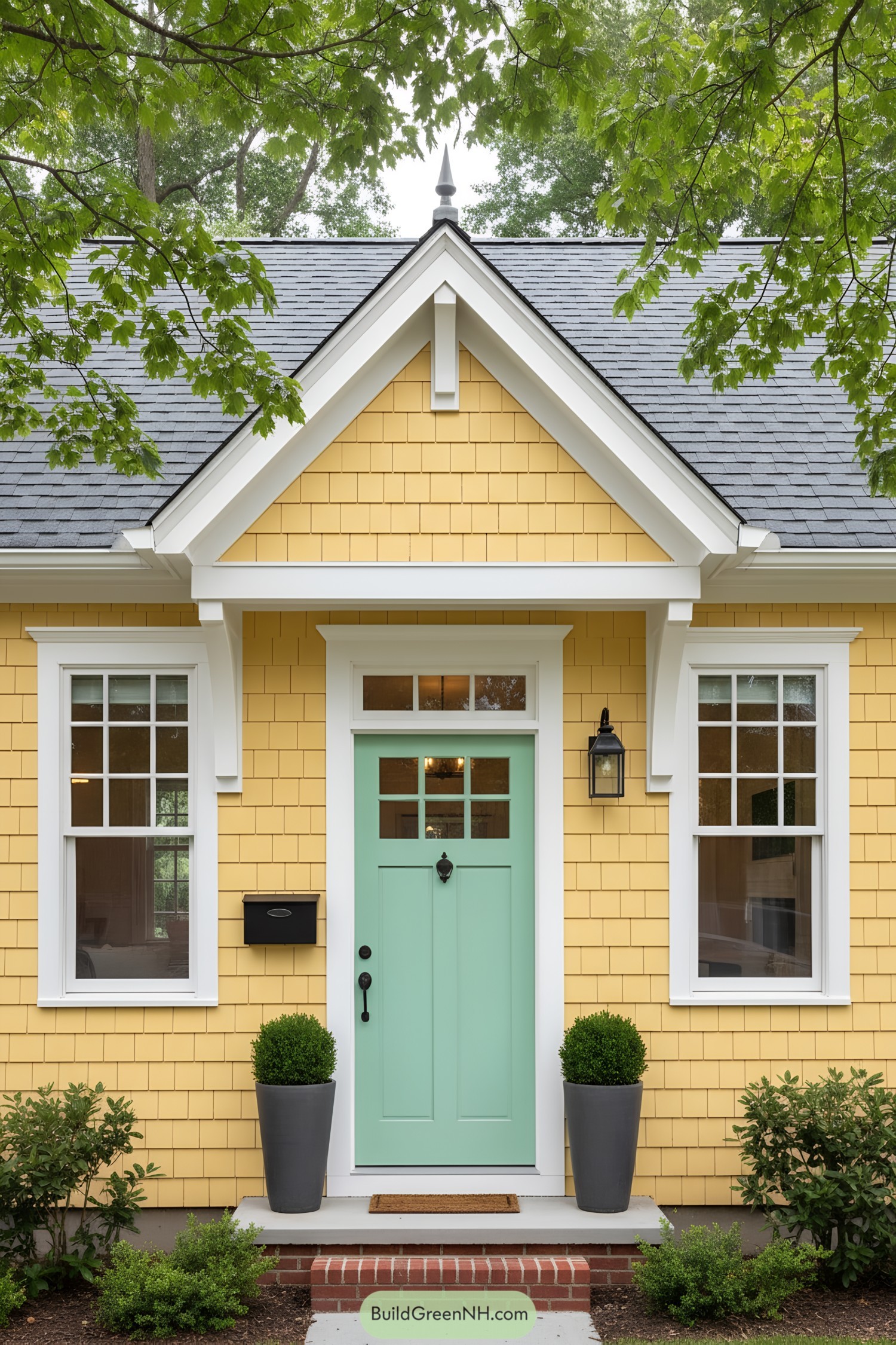 Yellow shingle facade with mint door