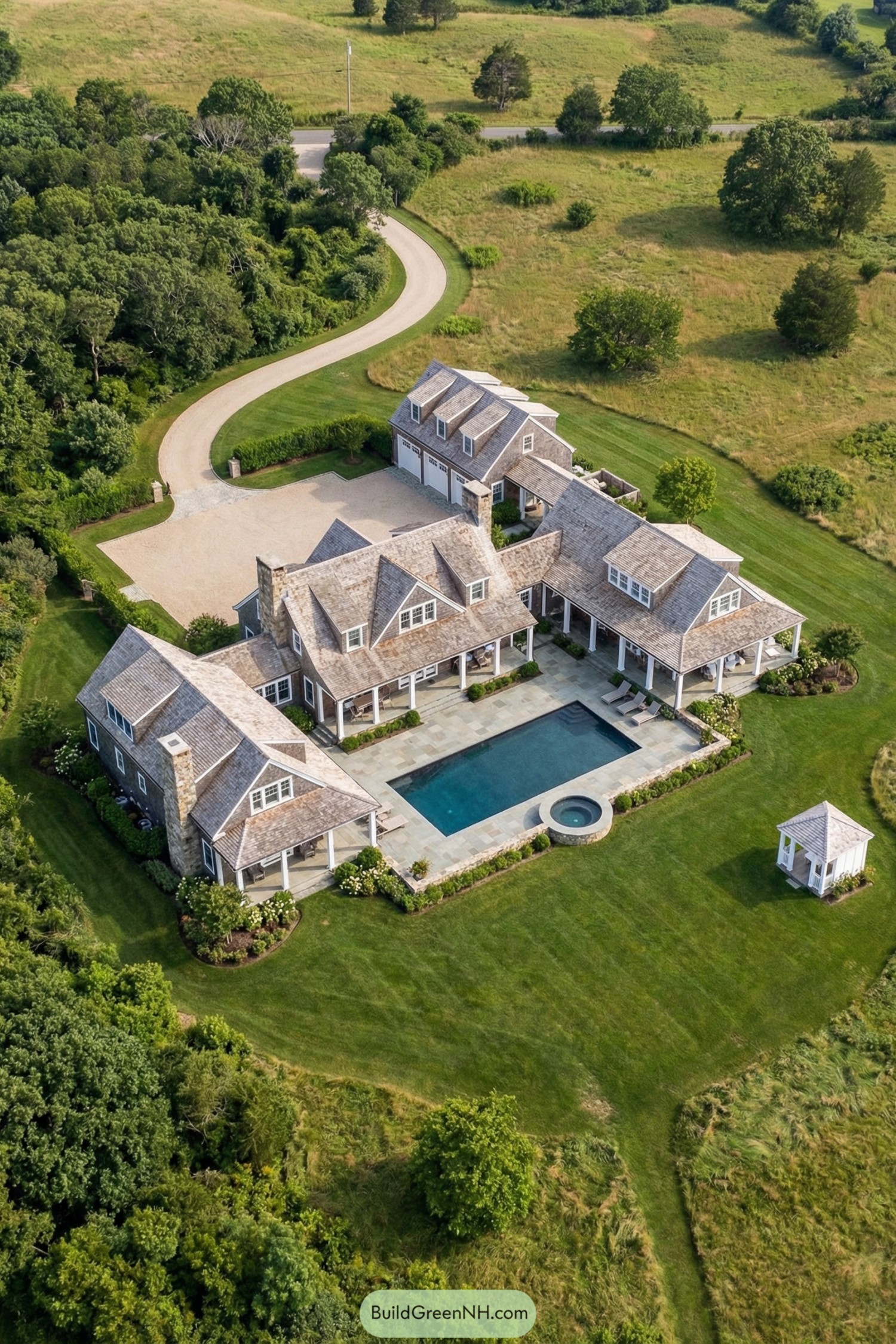 Aerial view of shingle-style family compound with central pool courtyard