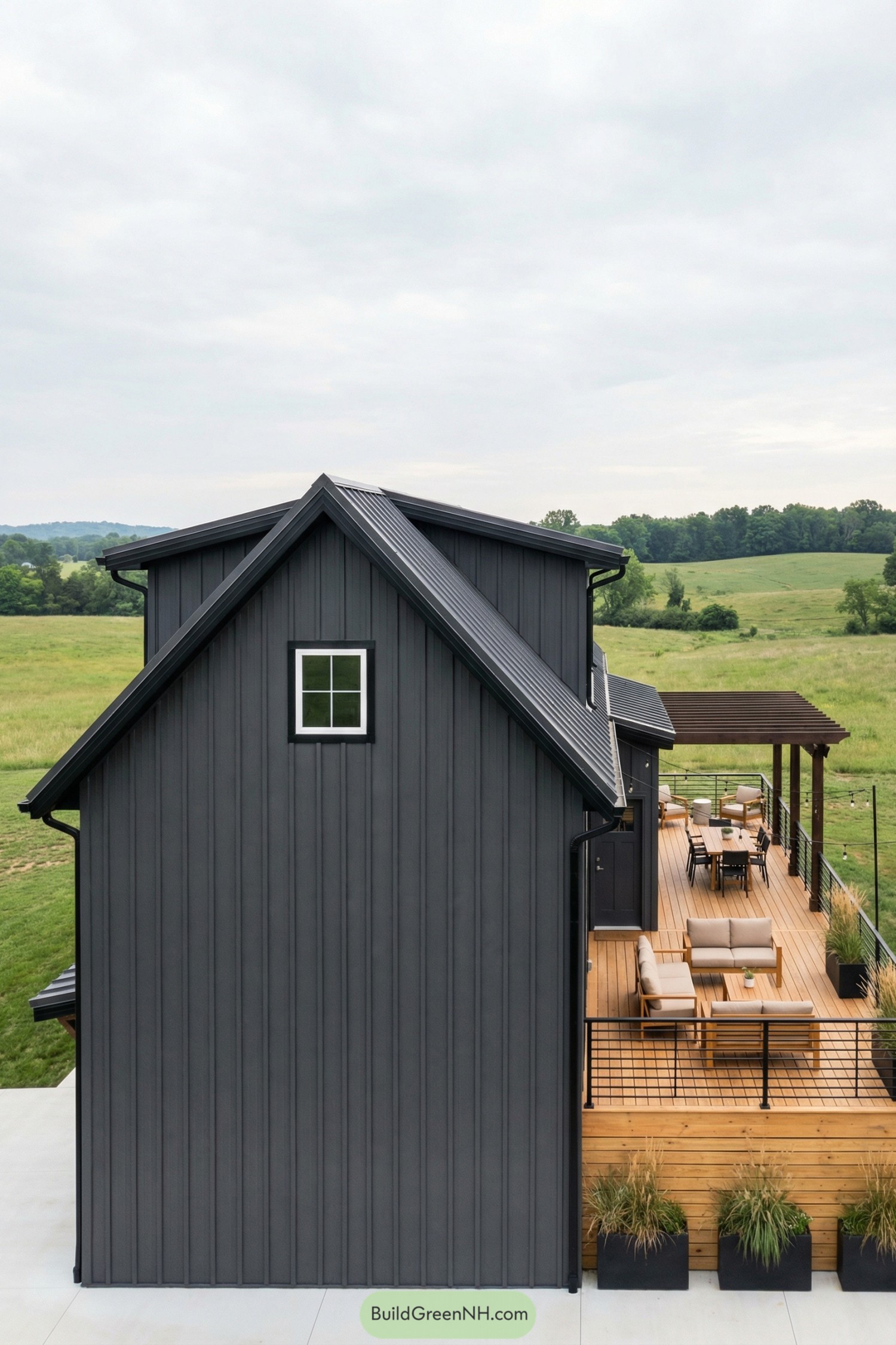 Dark metal barndominium with elevated wood deck