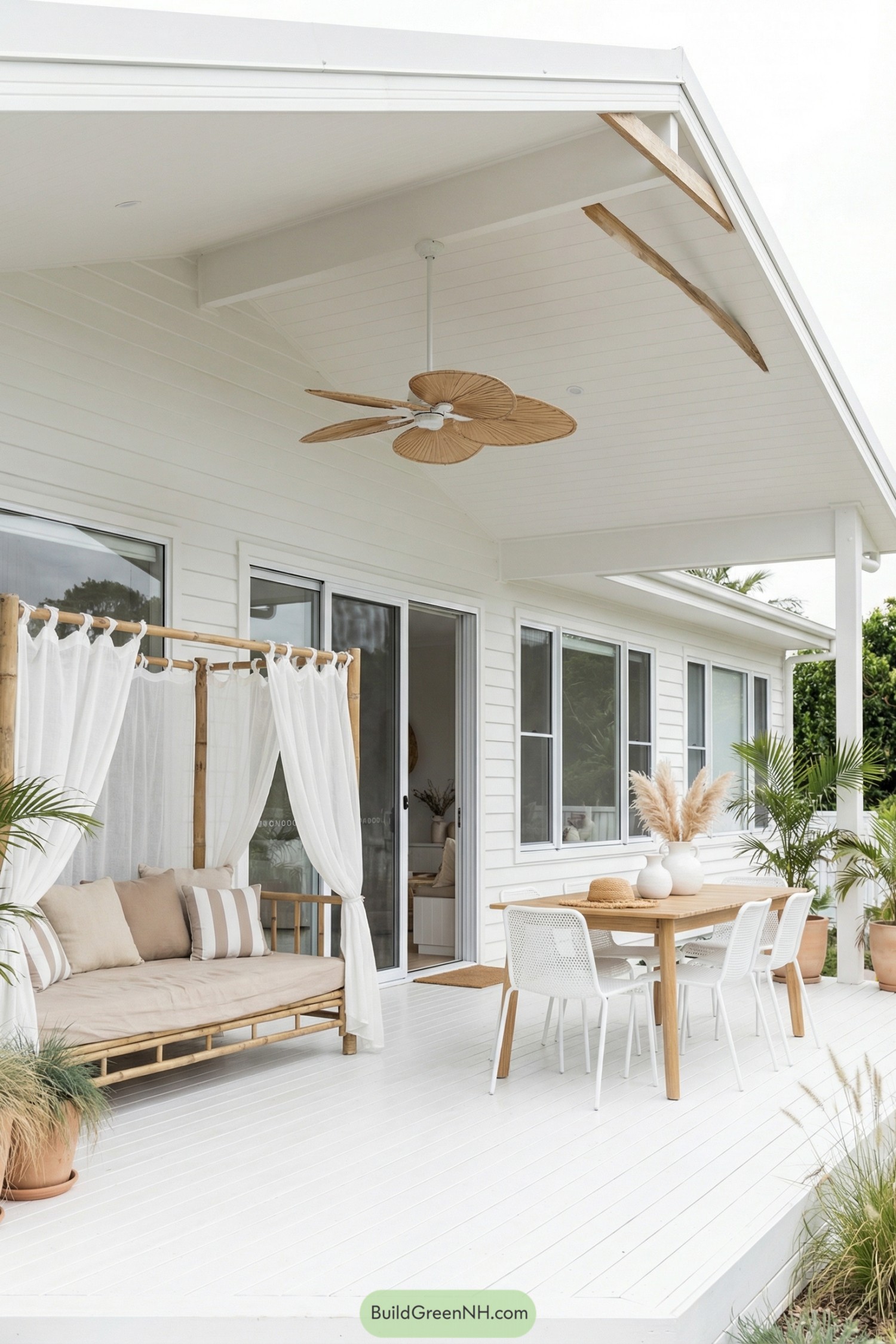 White coastal porch with bamboo daybed and dining set