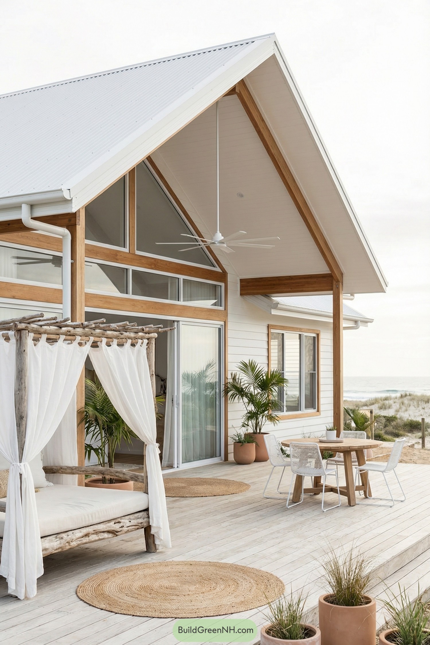 Light wood beach house deck with canopy daybed and ocean view