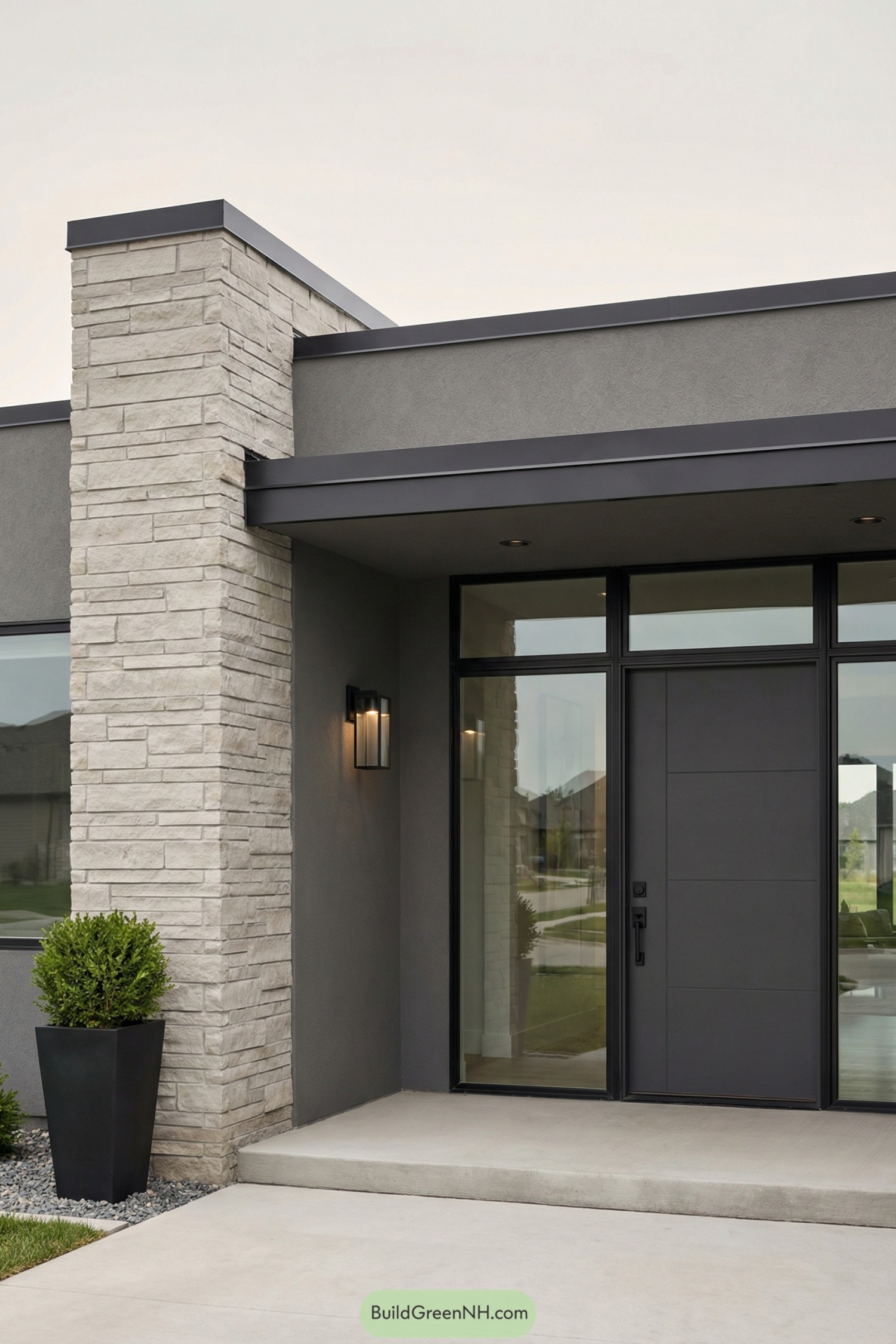 Modern gray home entrance with stone column and glass-framed front door