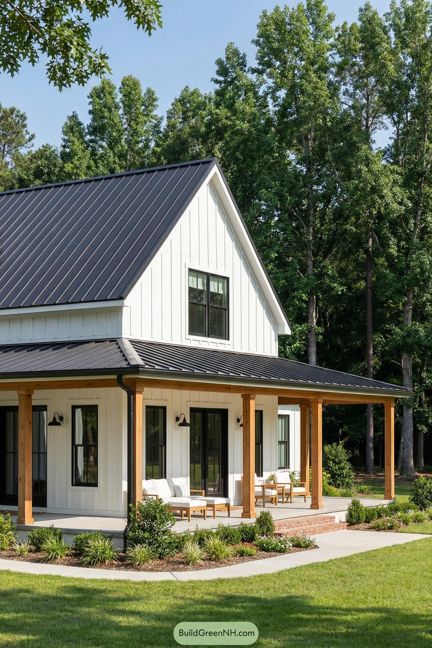 White board and batten farmhouse with black metal roof and wraparound porch