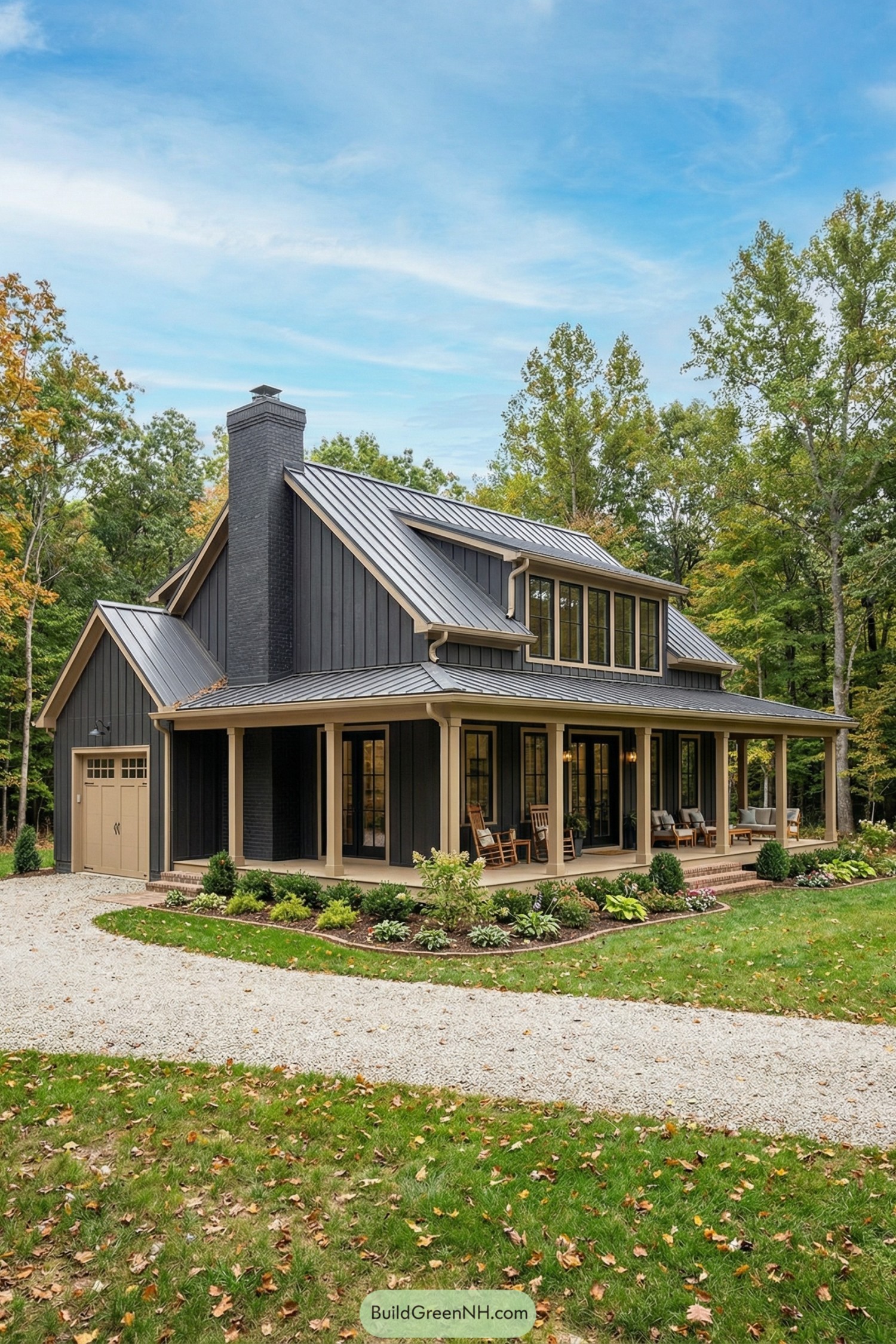 Dark gray cottage barndominium with metal roof and wraparound porch in a wooded setting
