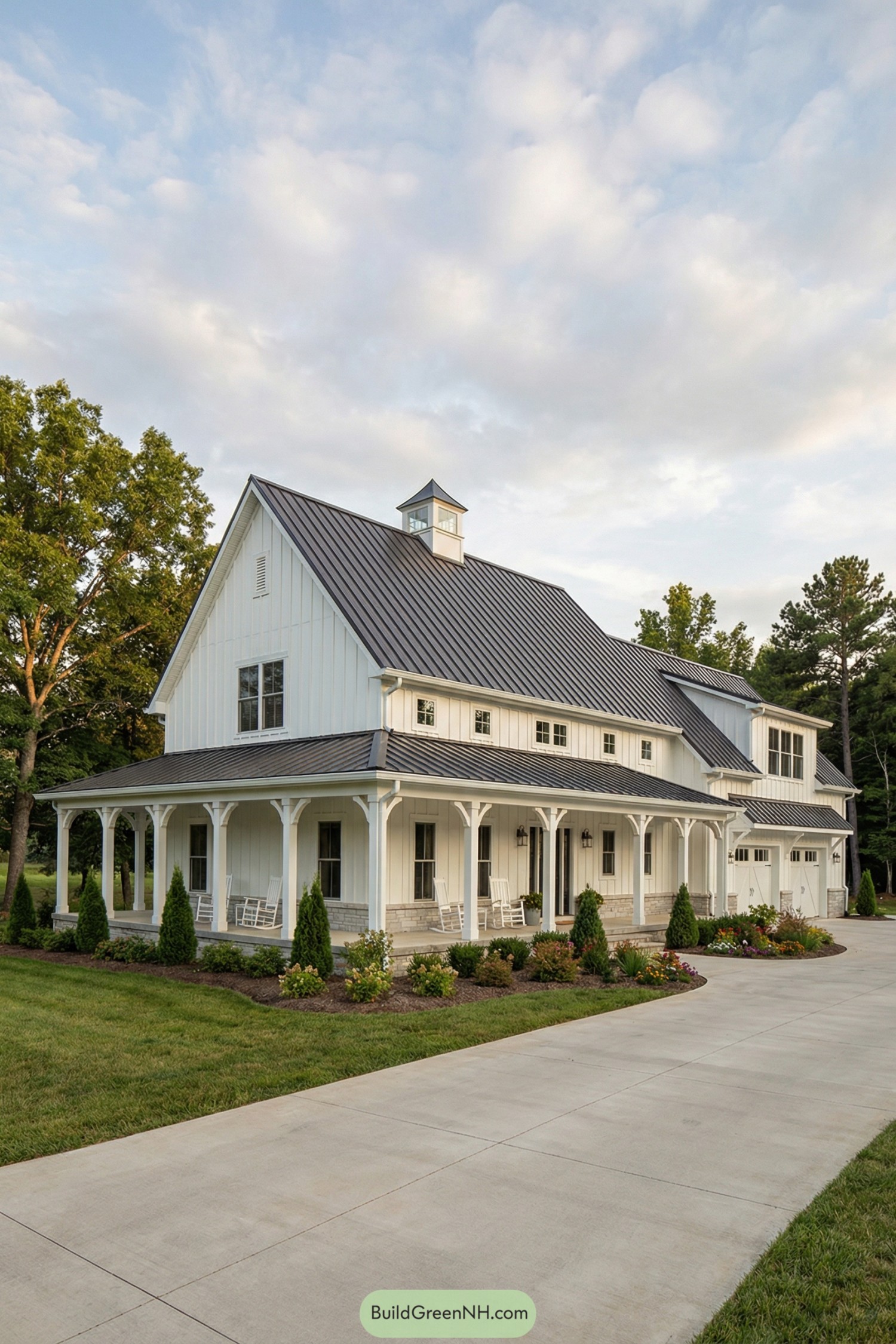 White farmhouse barndominium with metal roof and full wraparound porch