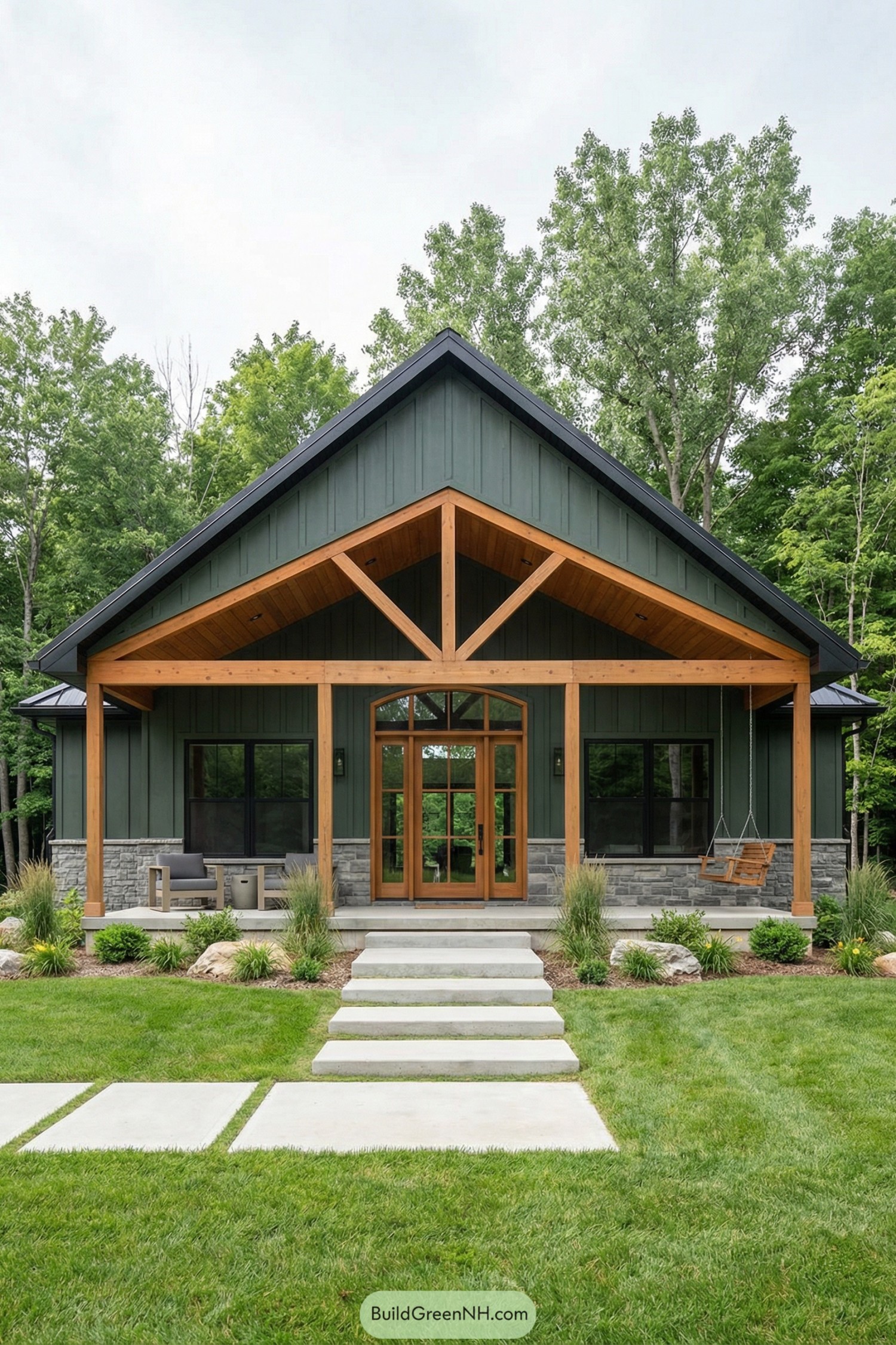 Green board-and-batten barndominium with timber porch and stone base