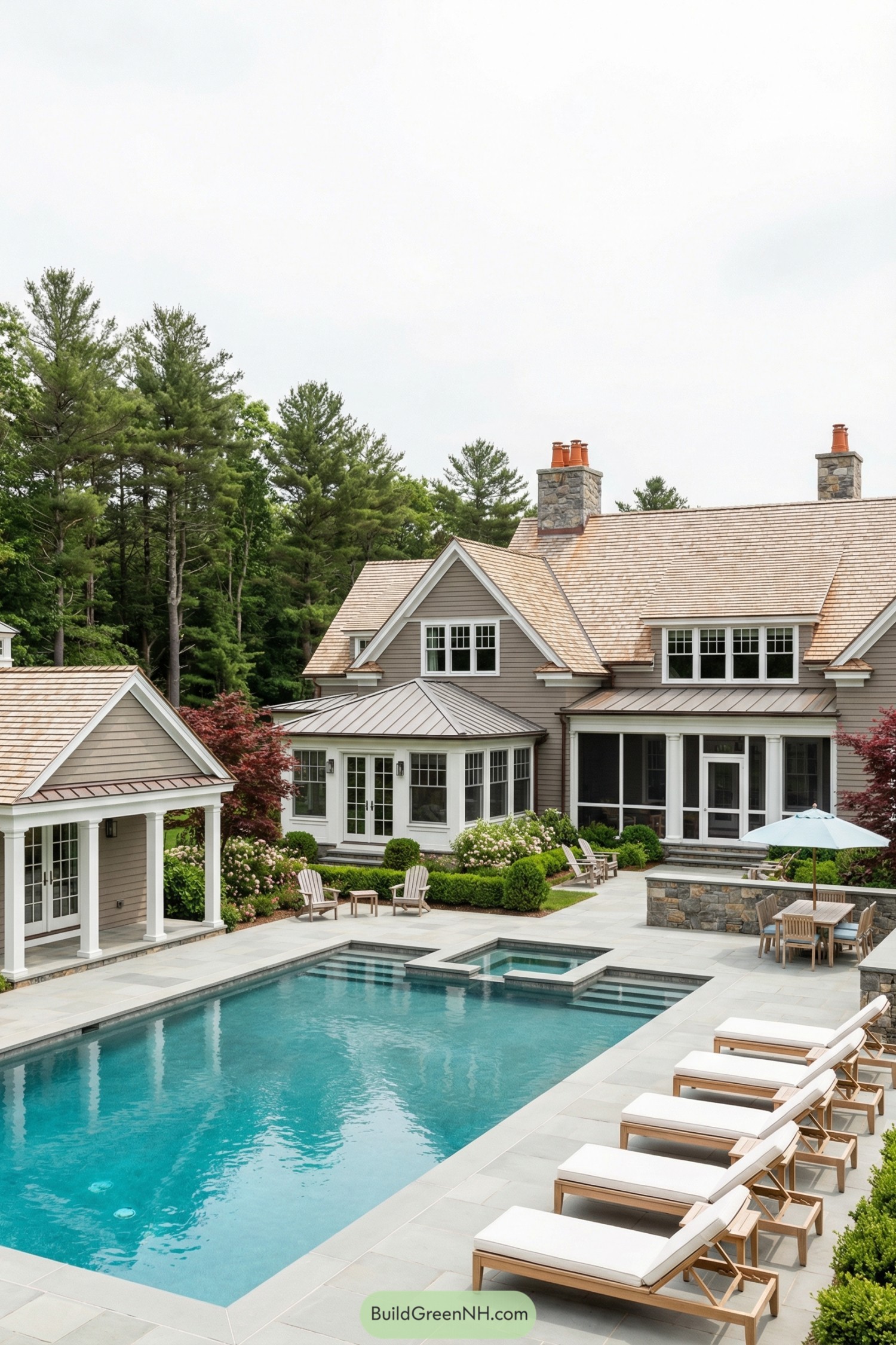 Classic shingle-style home with stone-trimmed pool terrace and spa