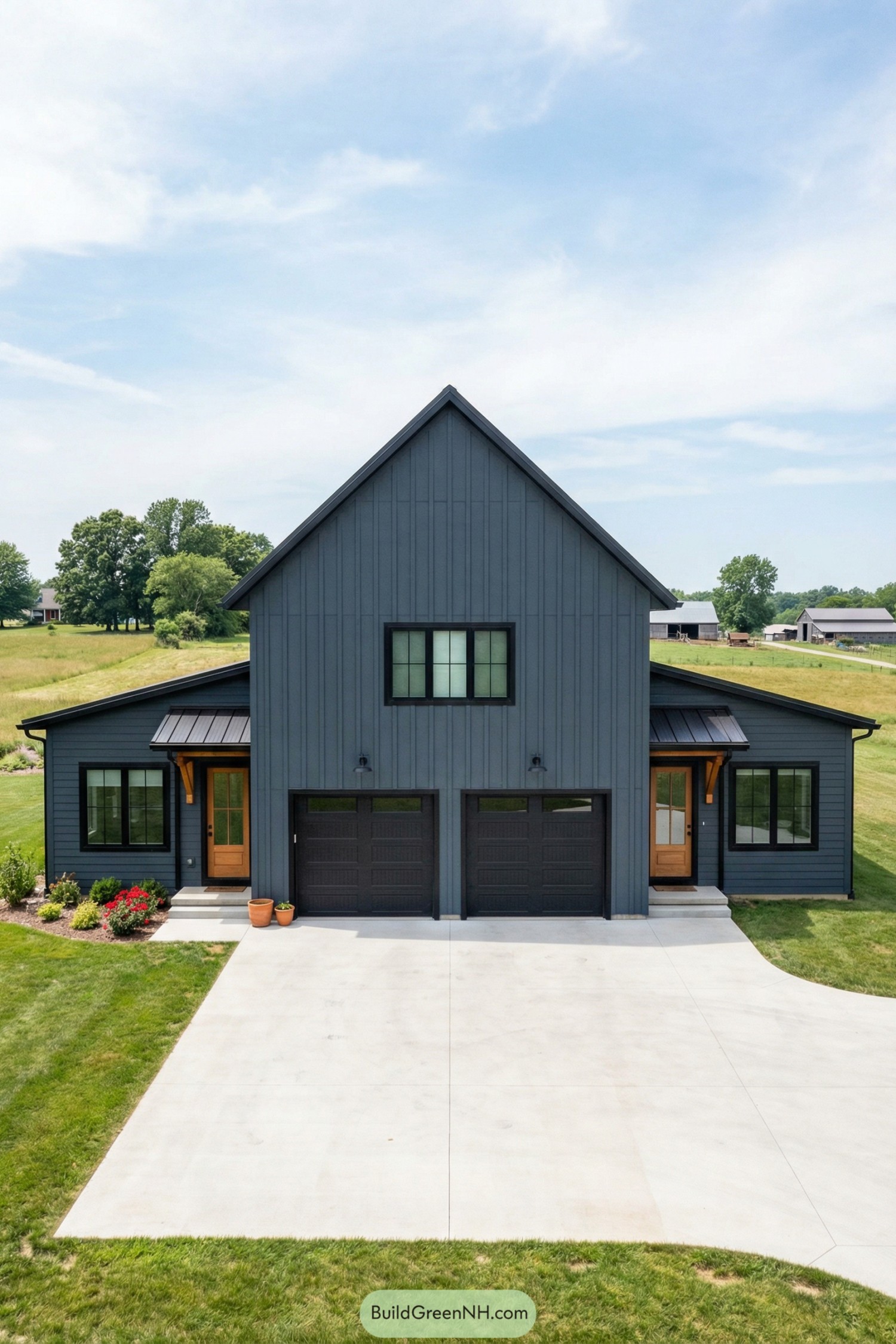 Modern dark charcoal garage house with tall central gable, side wings, and double garage doors on a wide concrete drive