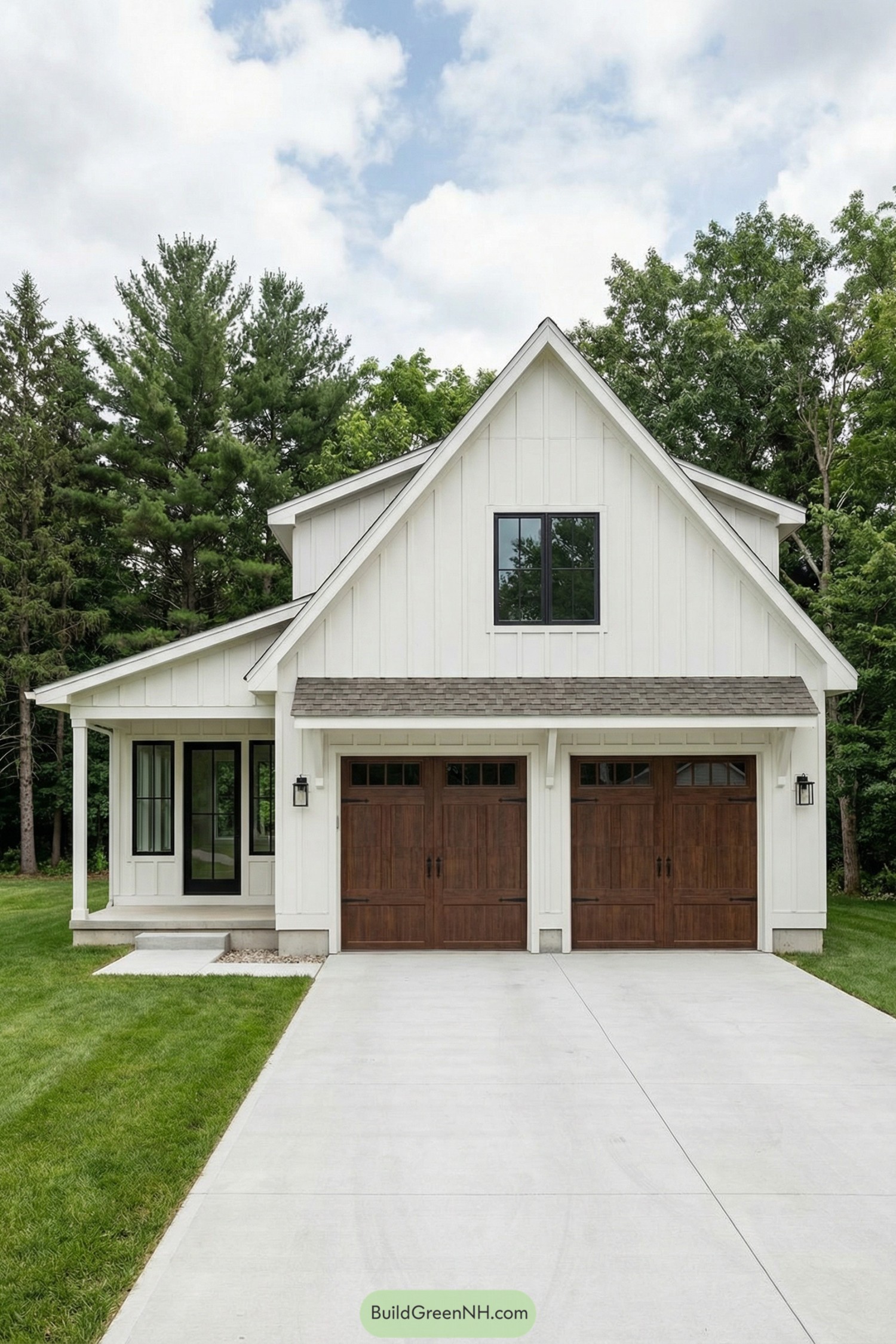 White board-and-batten garage with twin wood doors and small side porch set against trees