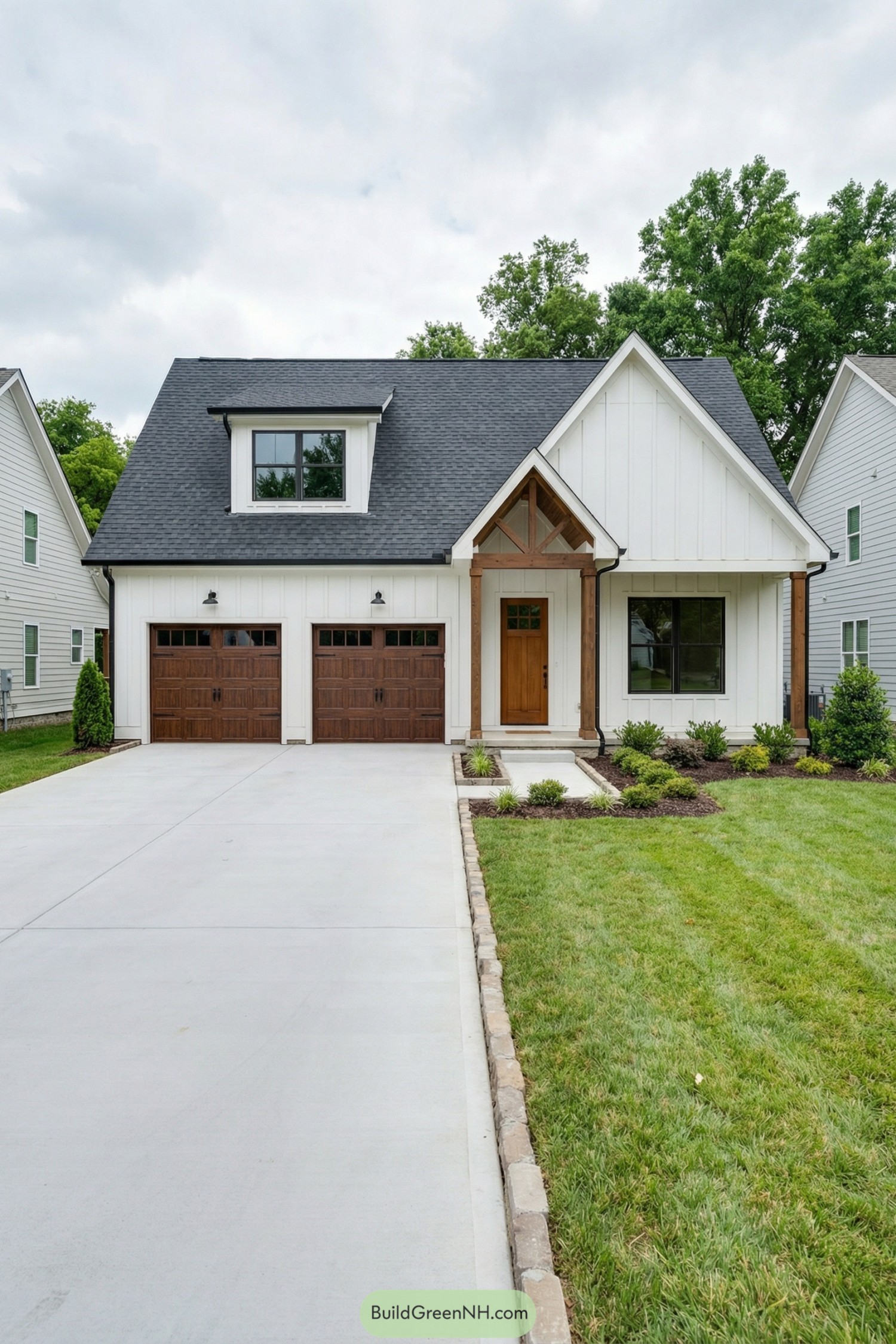 White board-and-batten house with double wooden garage doors and a steep gabled roof