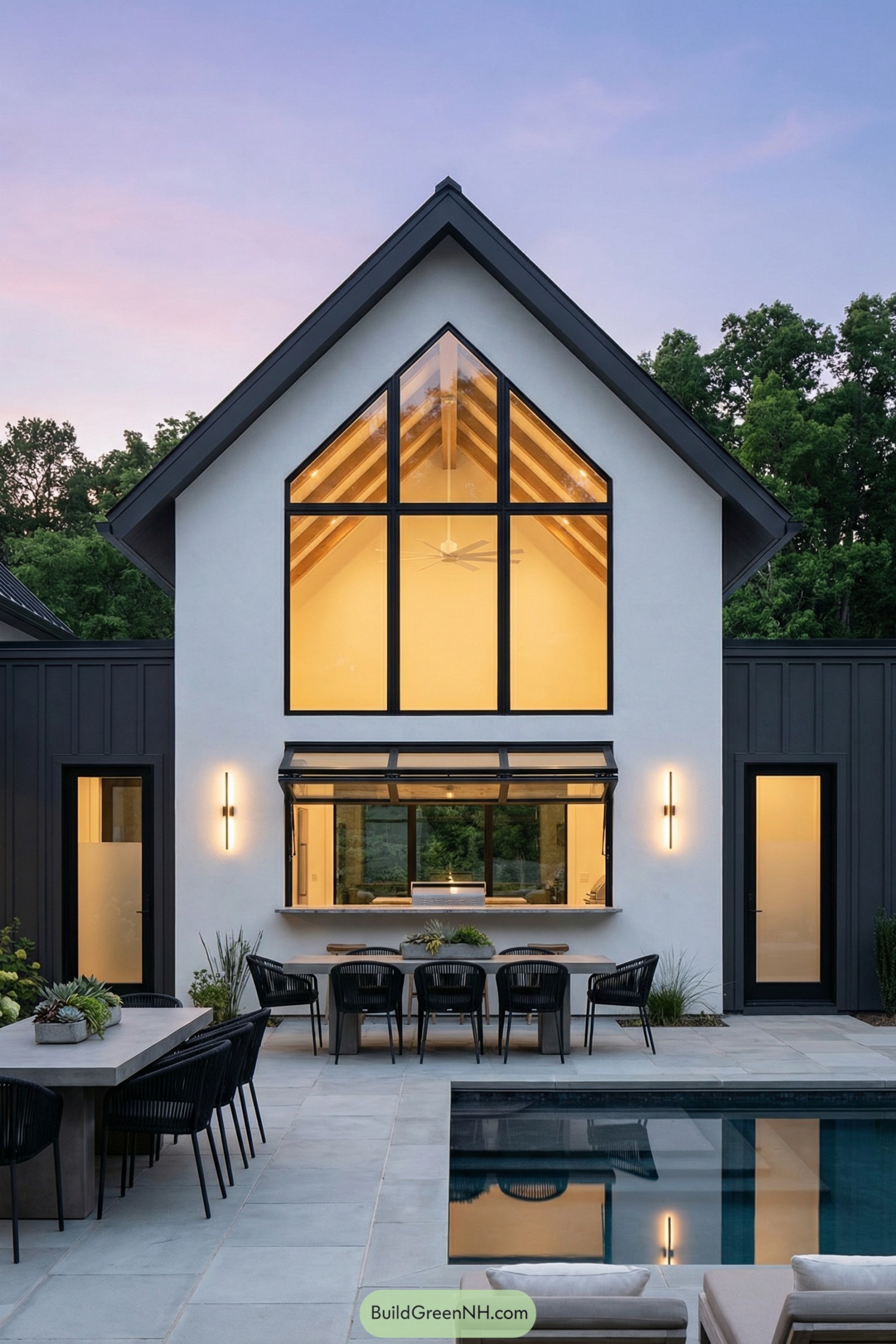 Modern gabled home with tall poolside windows
