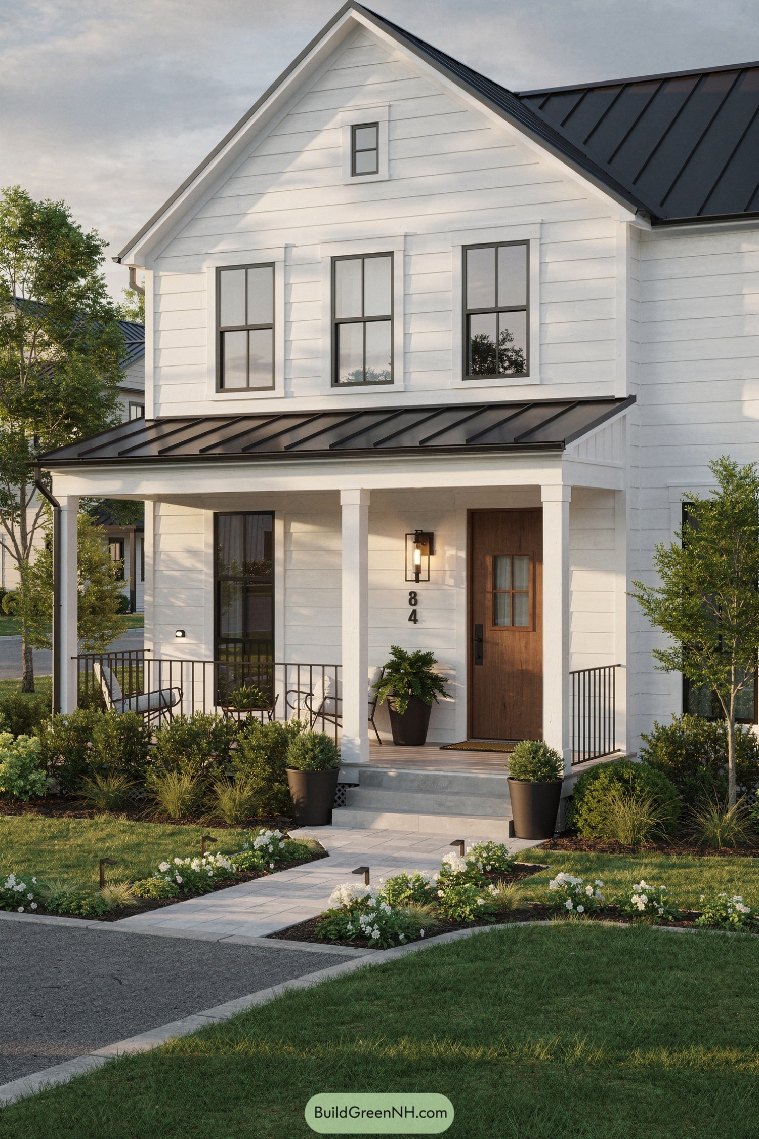 White shiplap house with black metal roof and cozy front porch