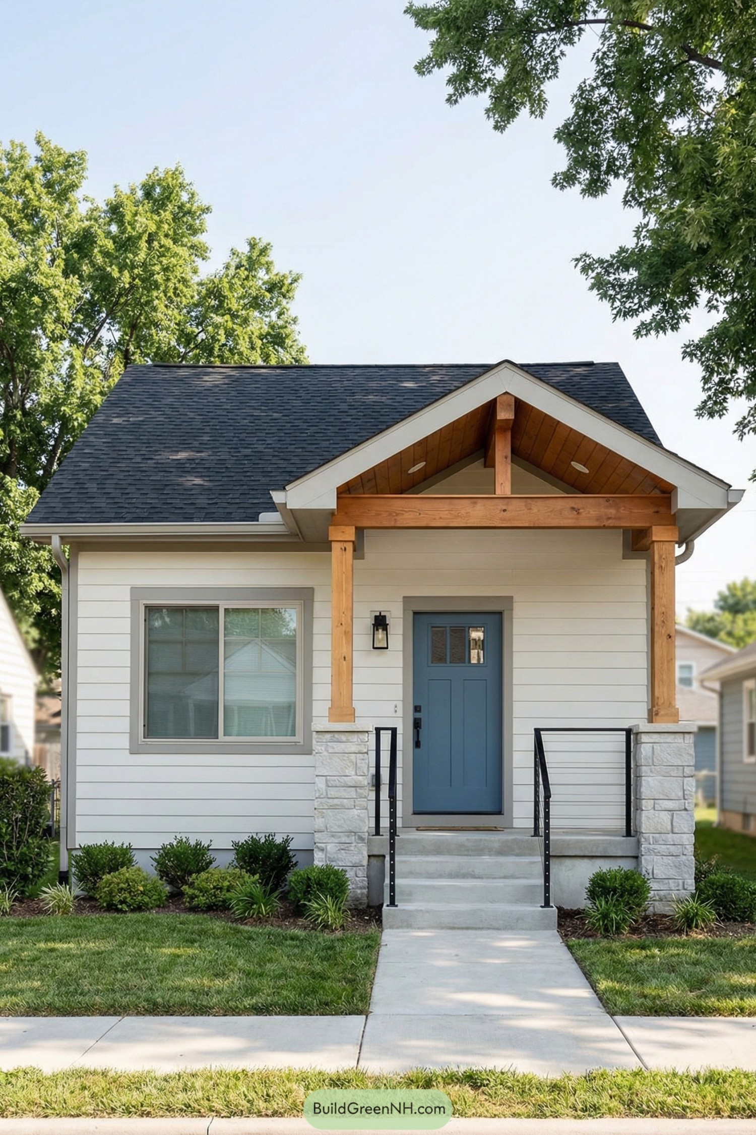 Small white house with blue front door and timber‑framed porch gable over a concrete stoop