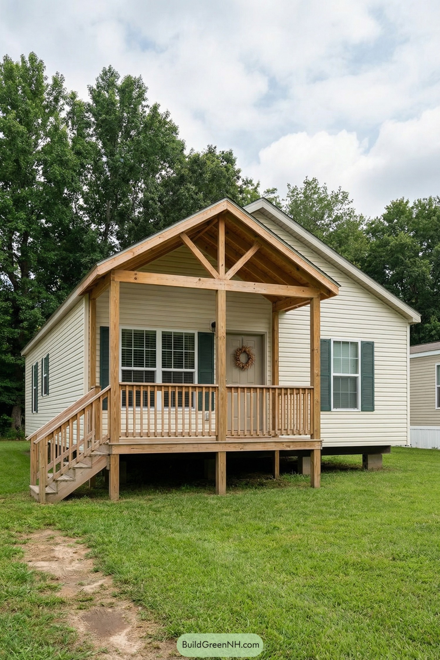 Small cream-colored cottage with raised wooden front porch and simple timber gable roof