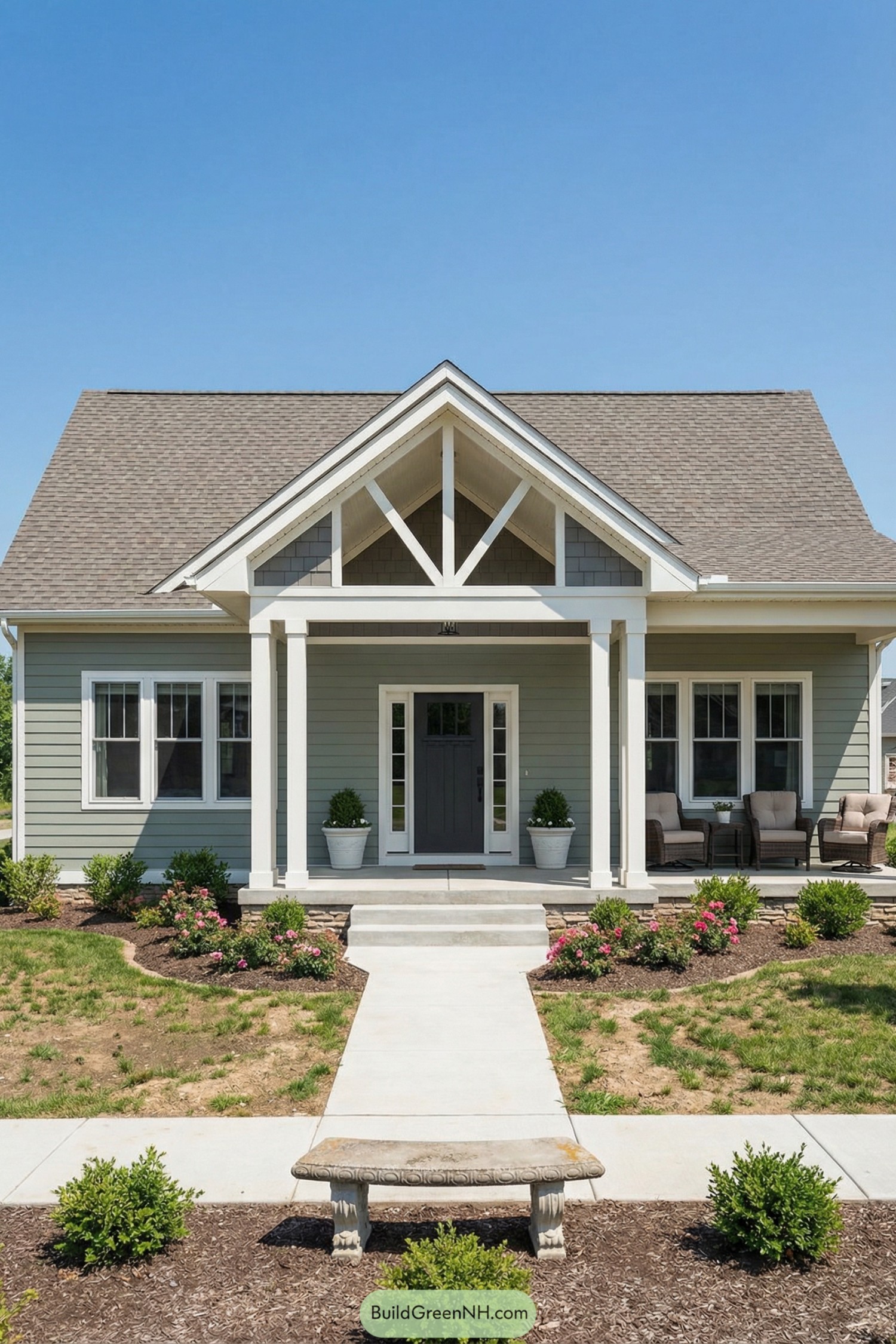 Light green cottage with prominent white porch gable and cozy seating