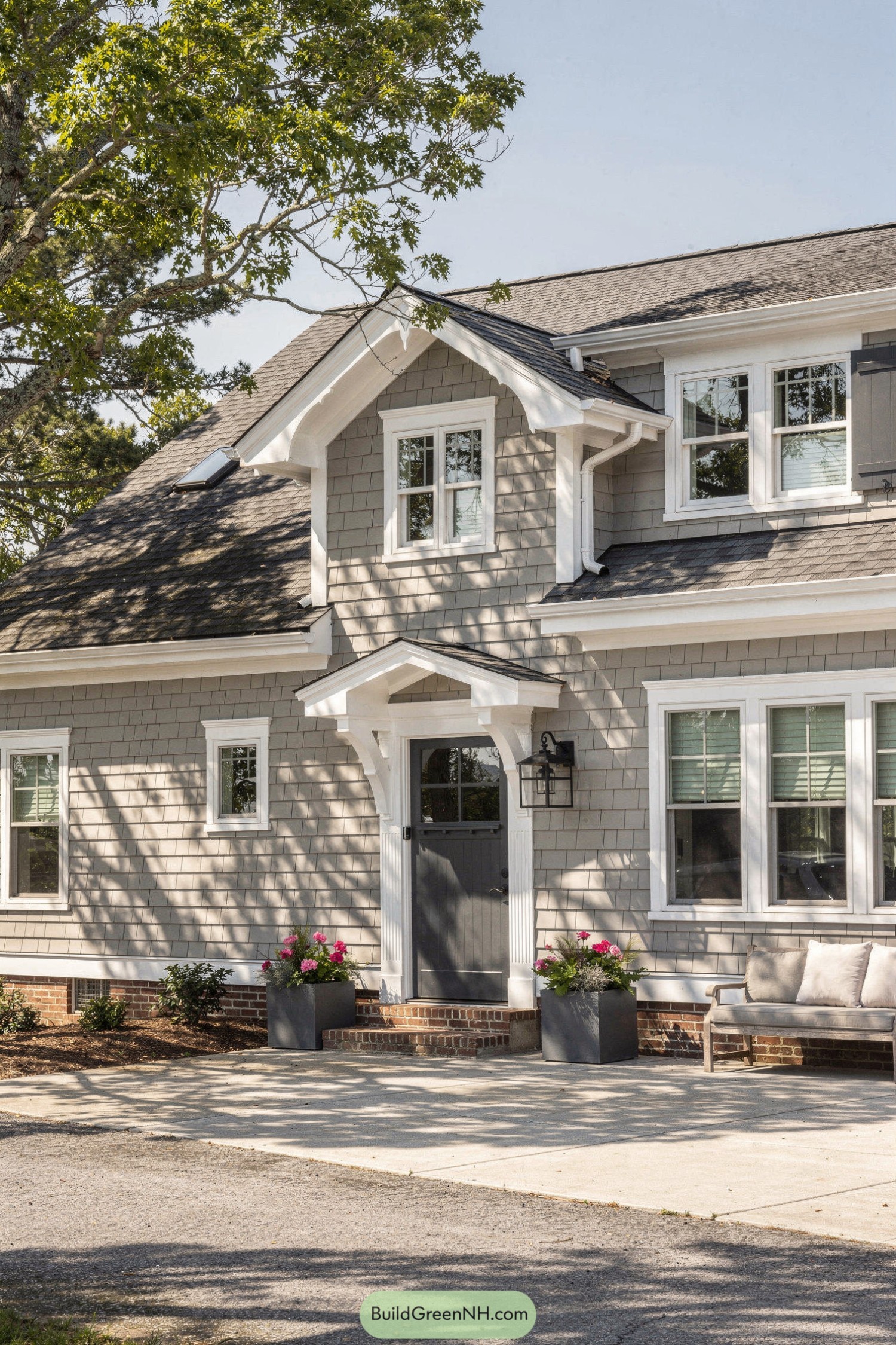 Light gray shingle house with white trim and cozy front entry