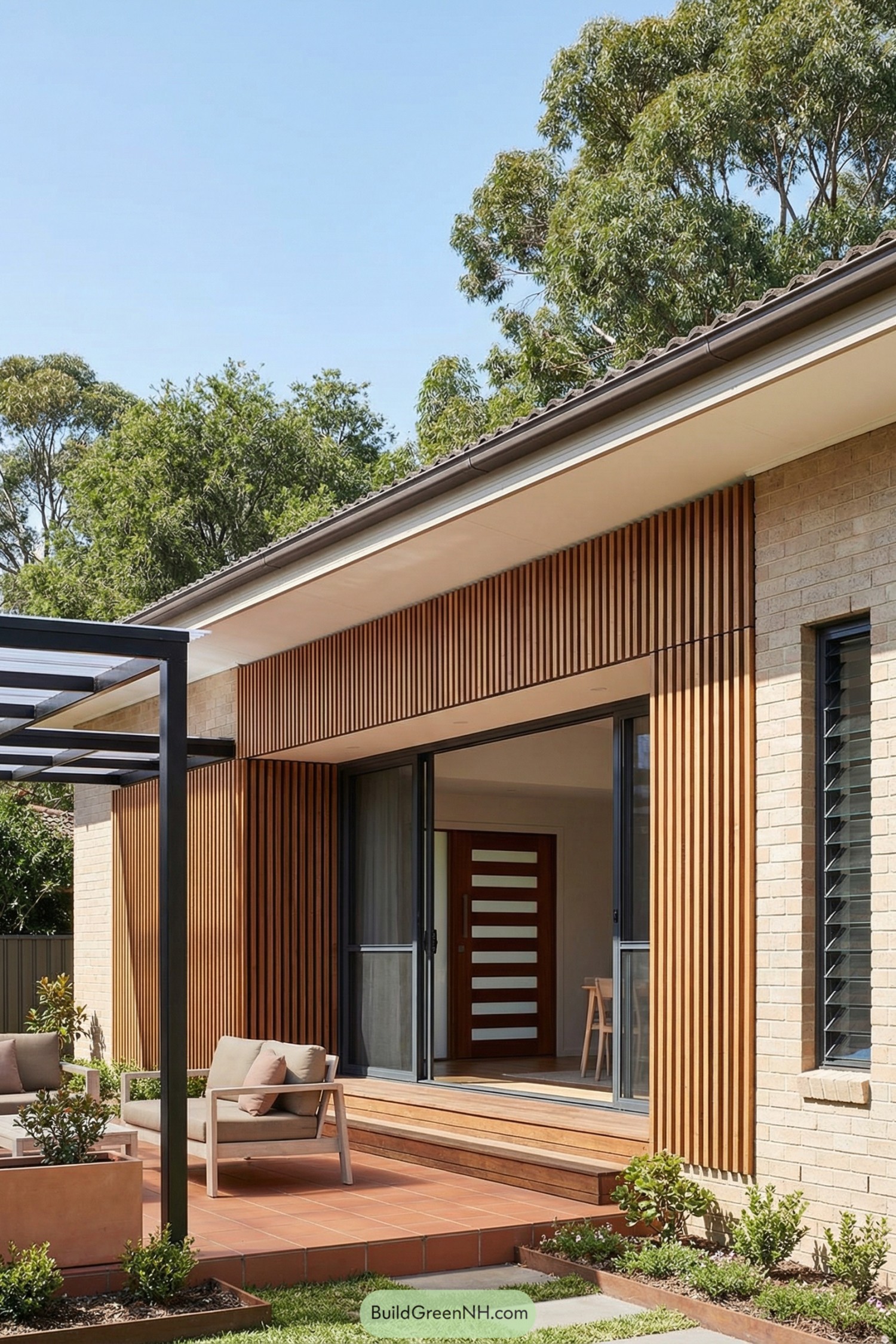 Modern brick home with vertical timber slats and tiled patio seating