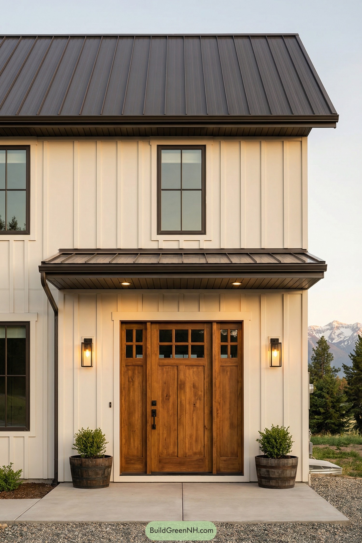 Modern farmhouse facade with warm wooden front door and metal awning roof