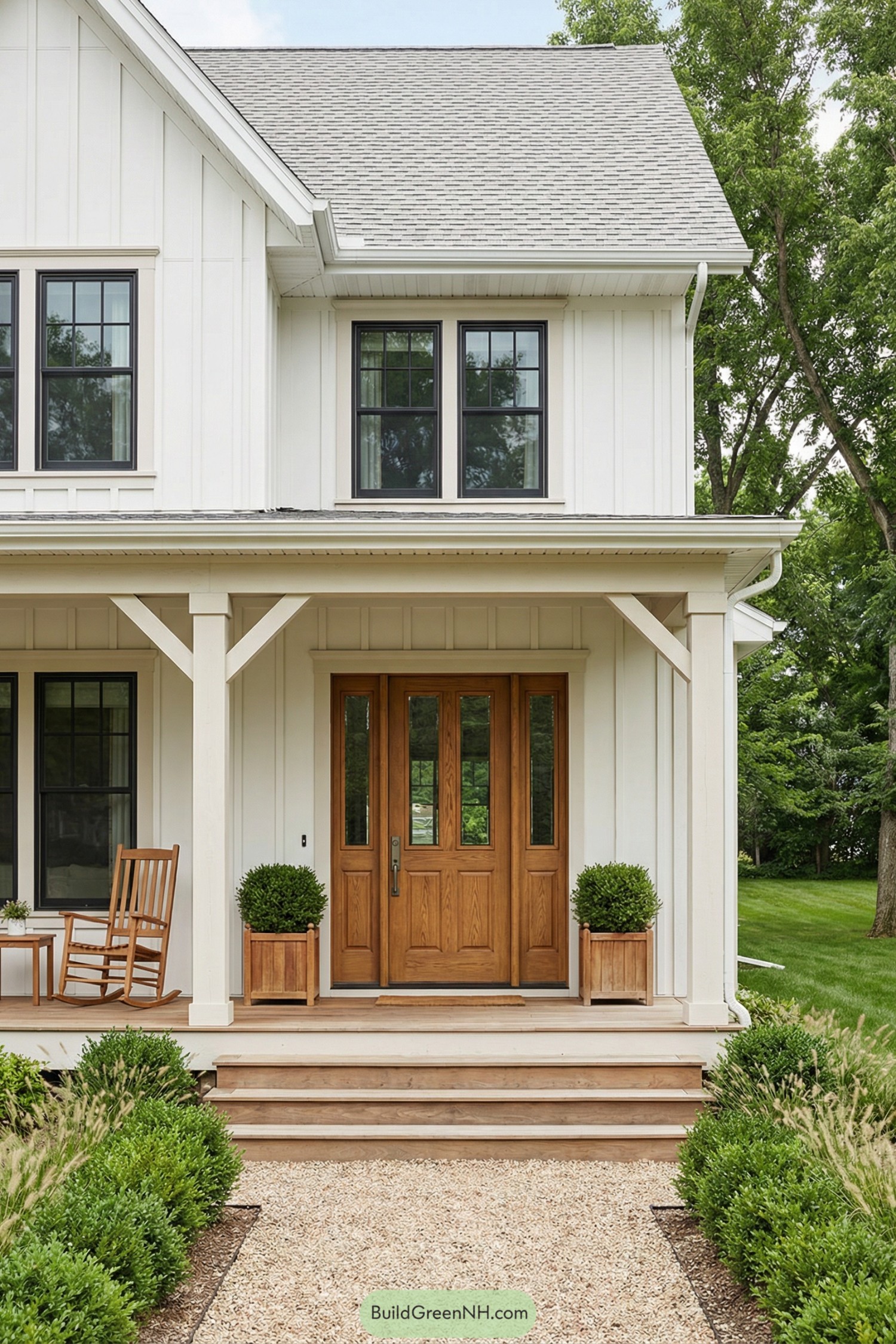 White farmhouse porch with warm wood front door