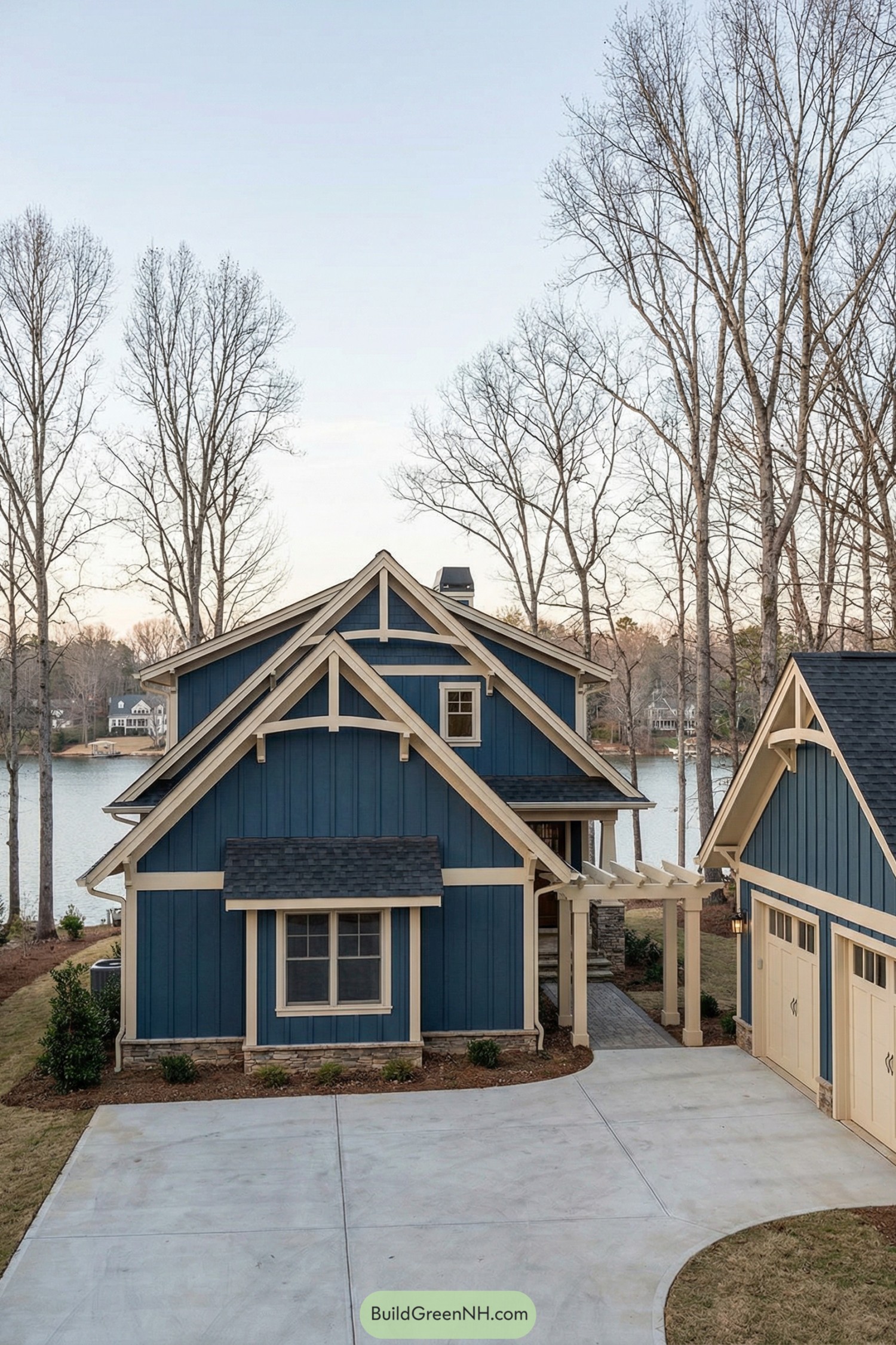 Blue lakeside Craftsman cottage with matching garage and pergola entry