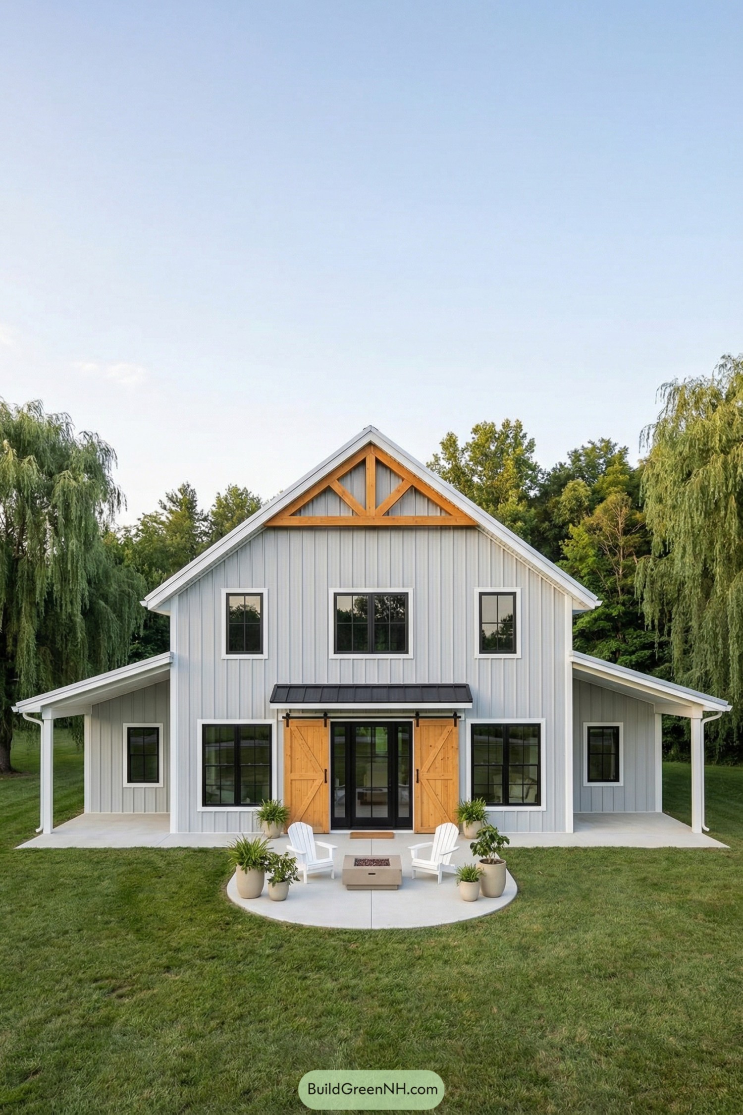 White barndominium with wood trim and patio