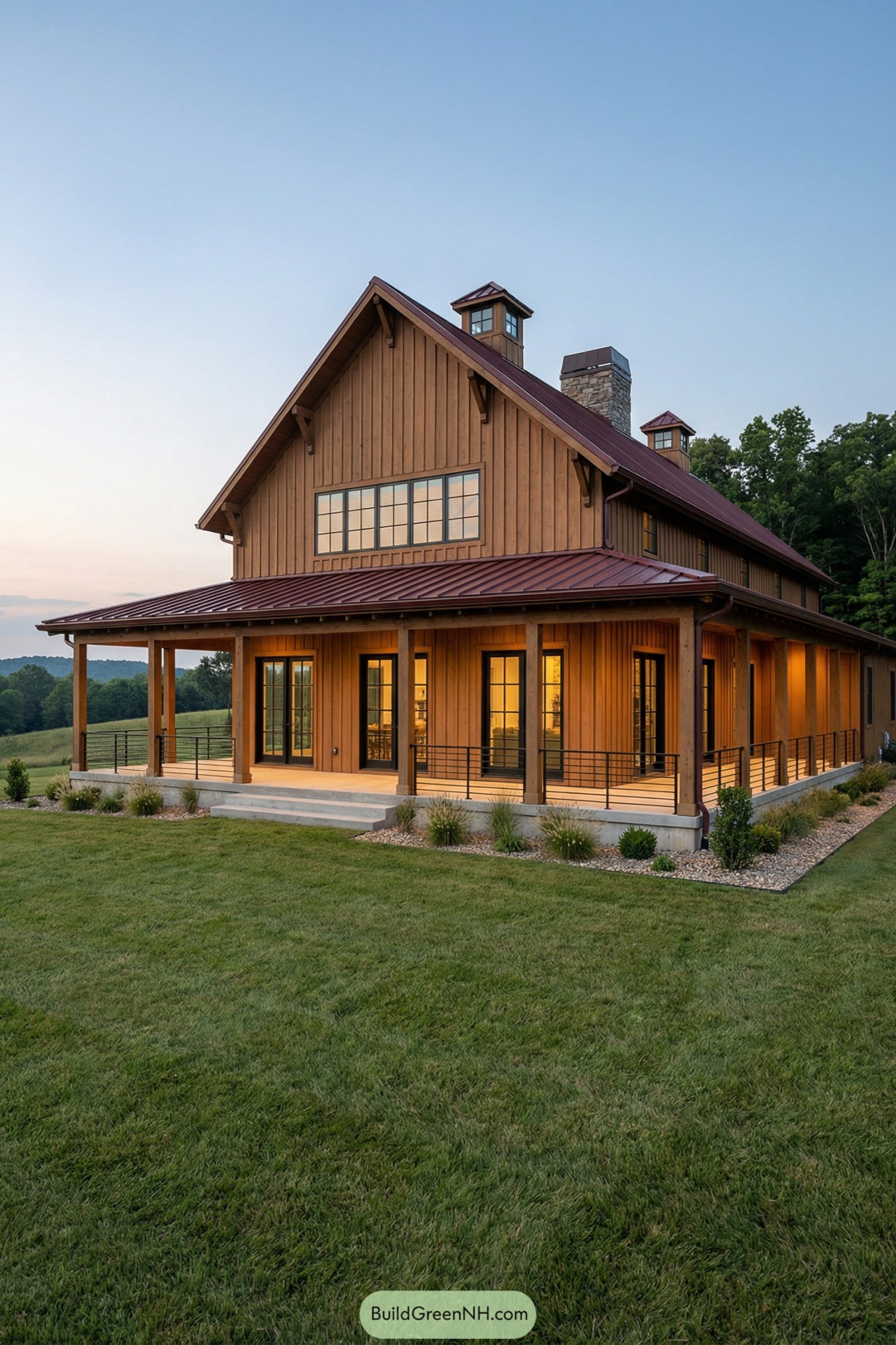 Two-story wood barndominium with wraparound porch at sunset