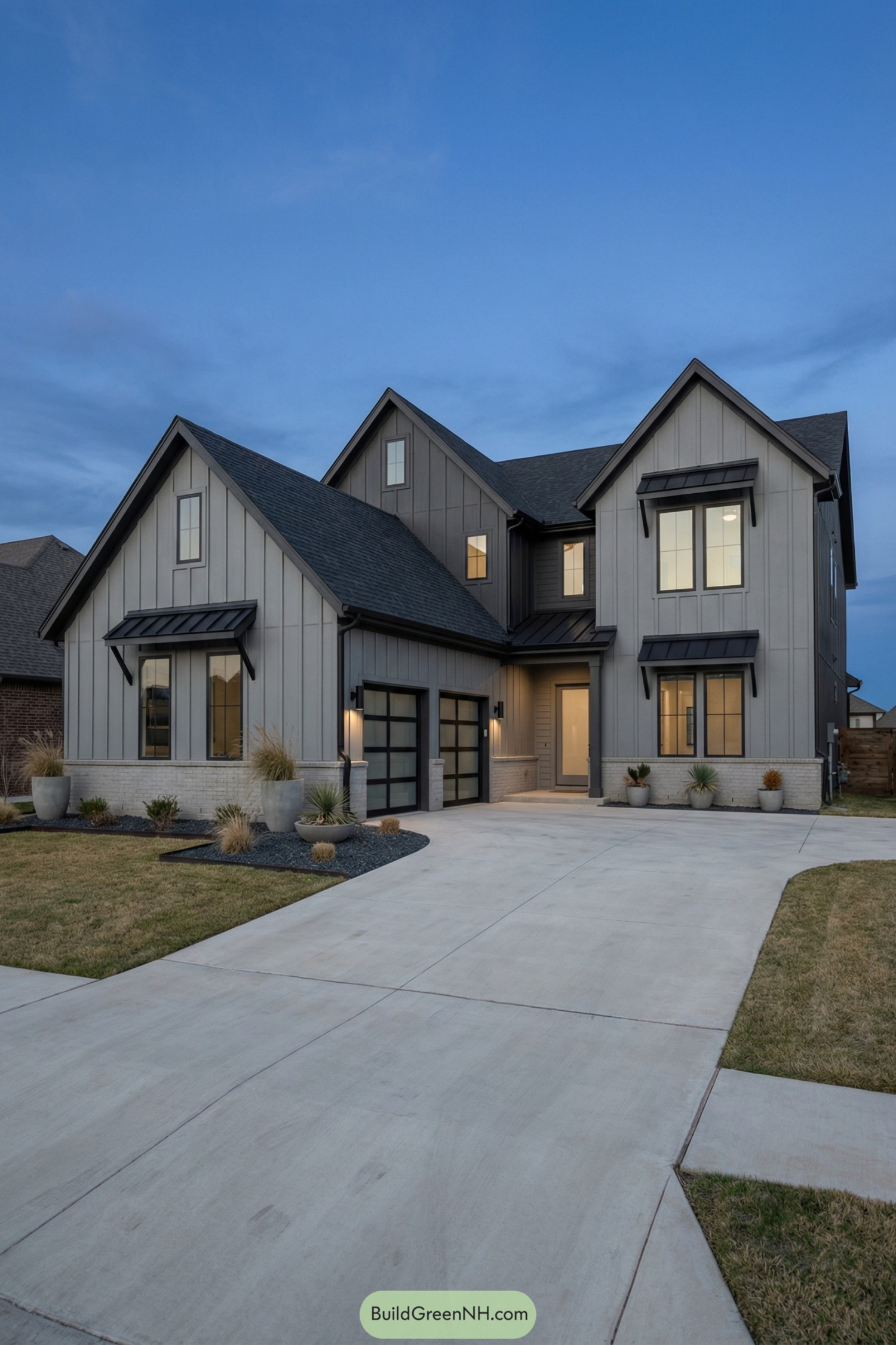 Two-story modern grey gabled house at dusk