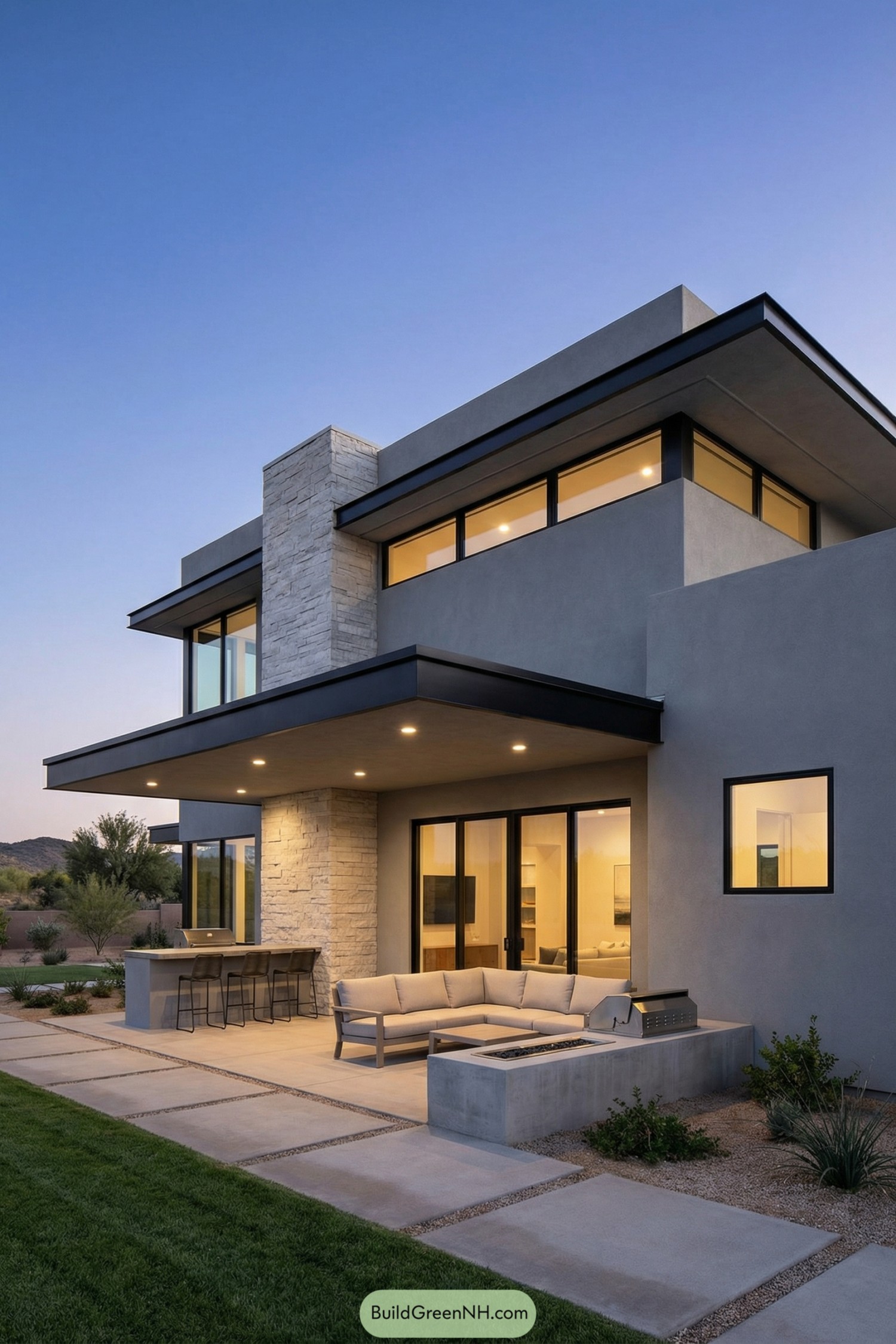 Modern grey two-story house with wide overhangs and a cozy patio