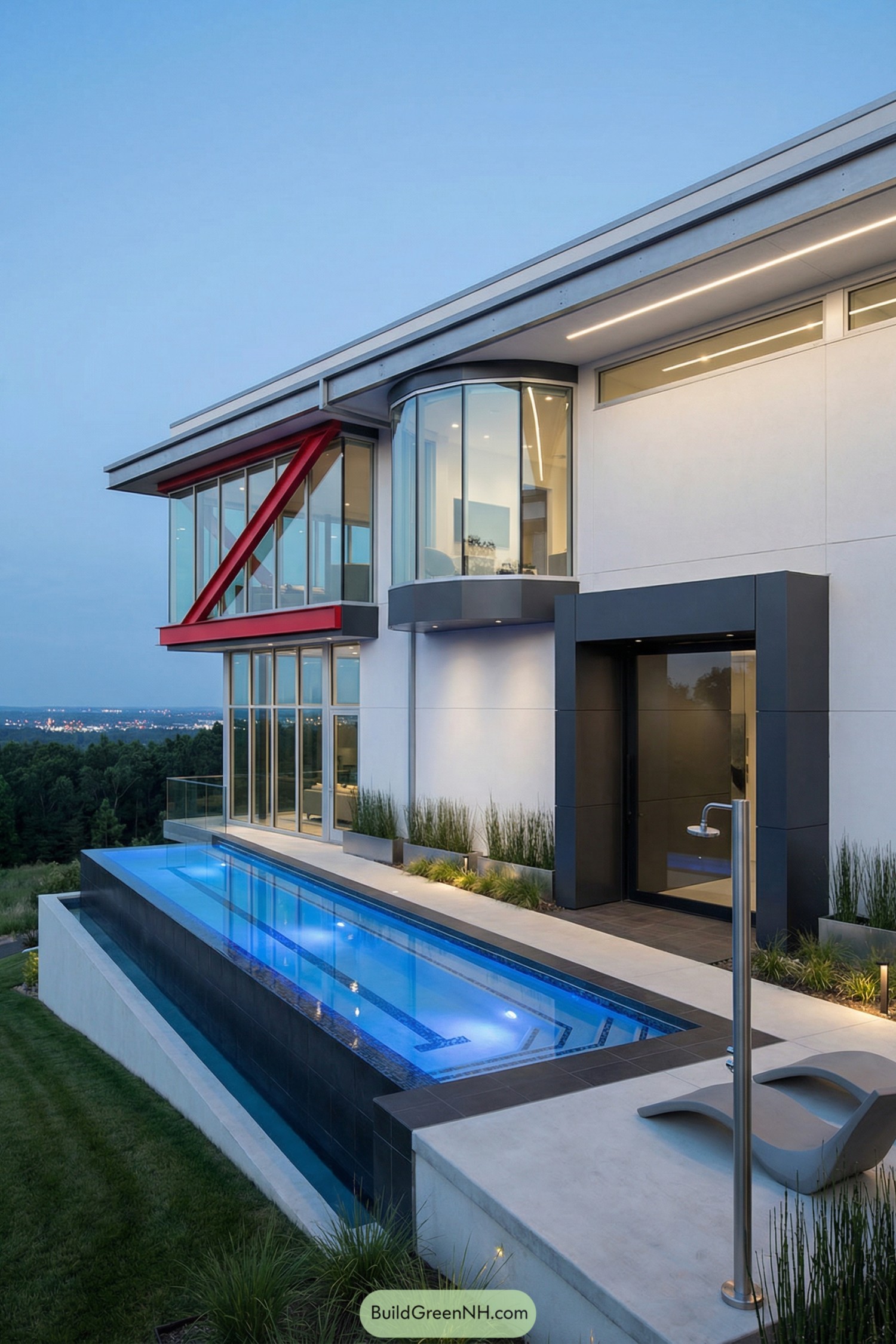 Modern hillside glass house with narrow illuminated pool