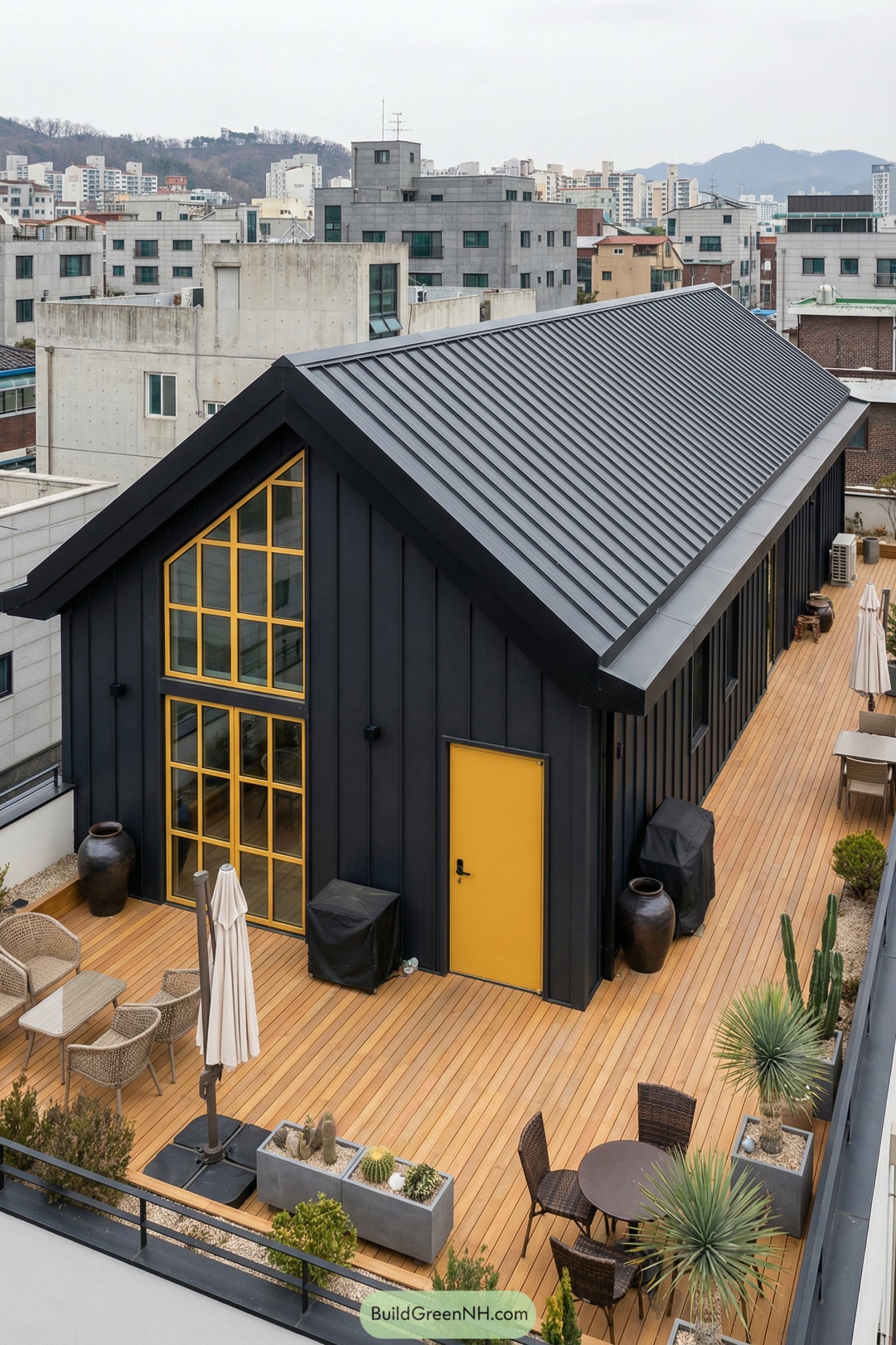 Black metal gable house with yellow accents on a spacious rooftop deck