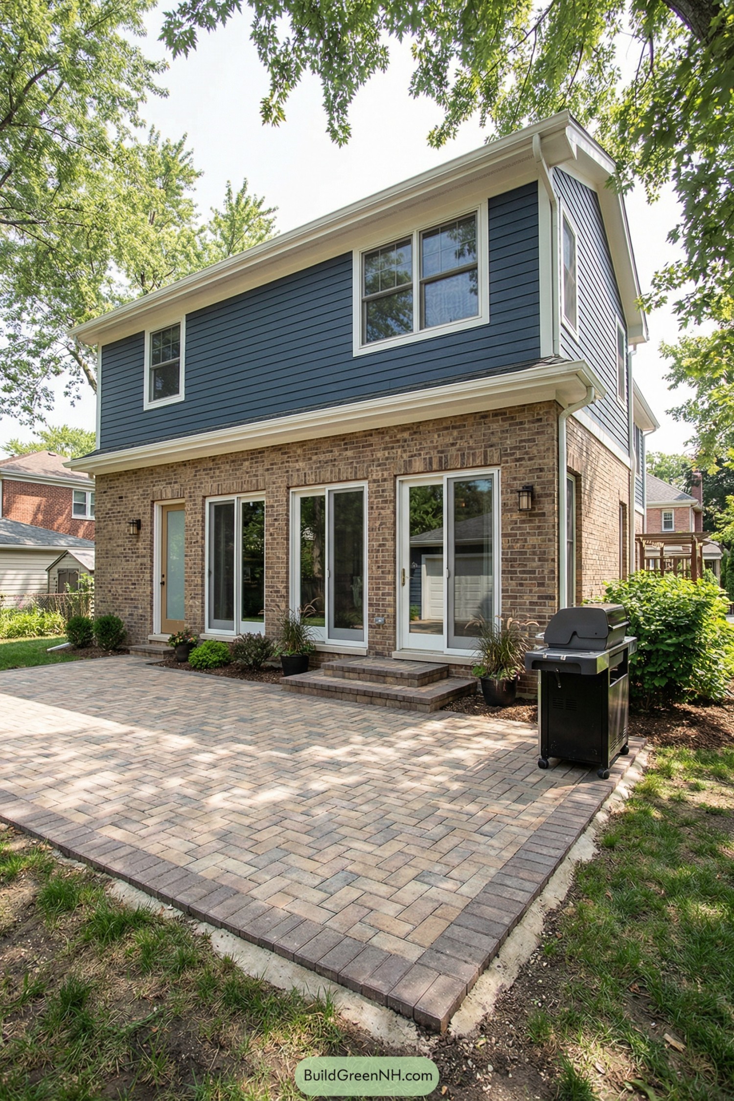 Brick courtyard patio outside two-story home