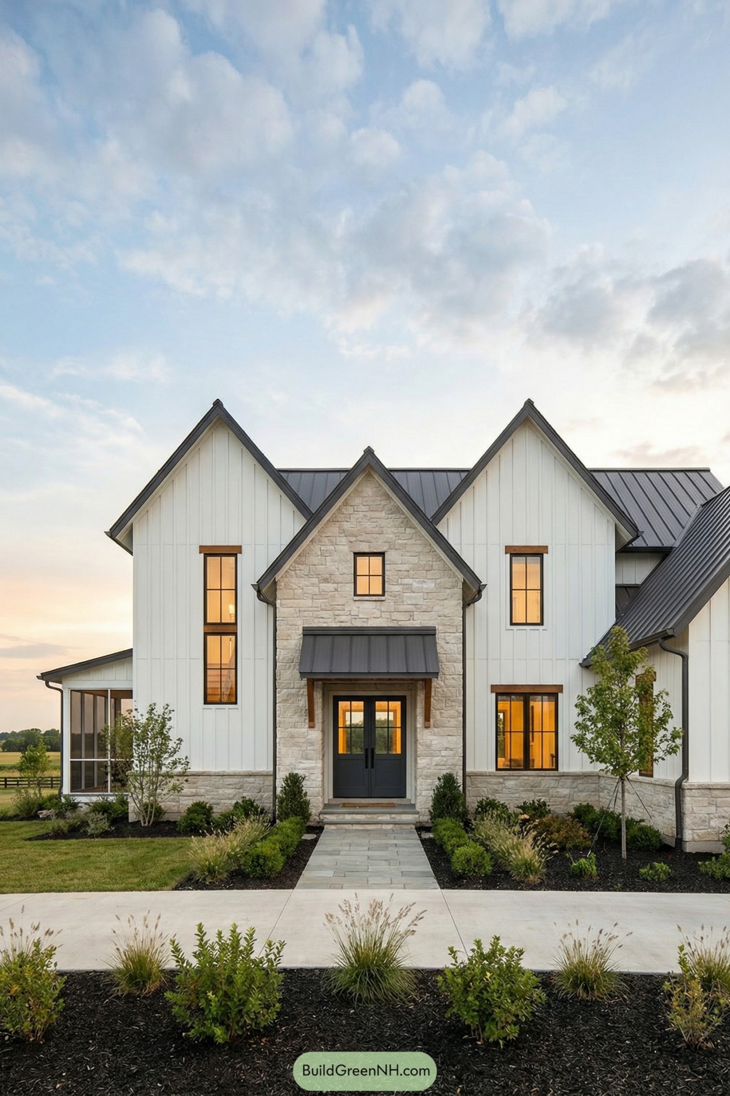 Modern farmhouse with tall gables stone and board-and-batten siding, metal roof, and landscaped front path