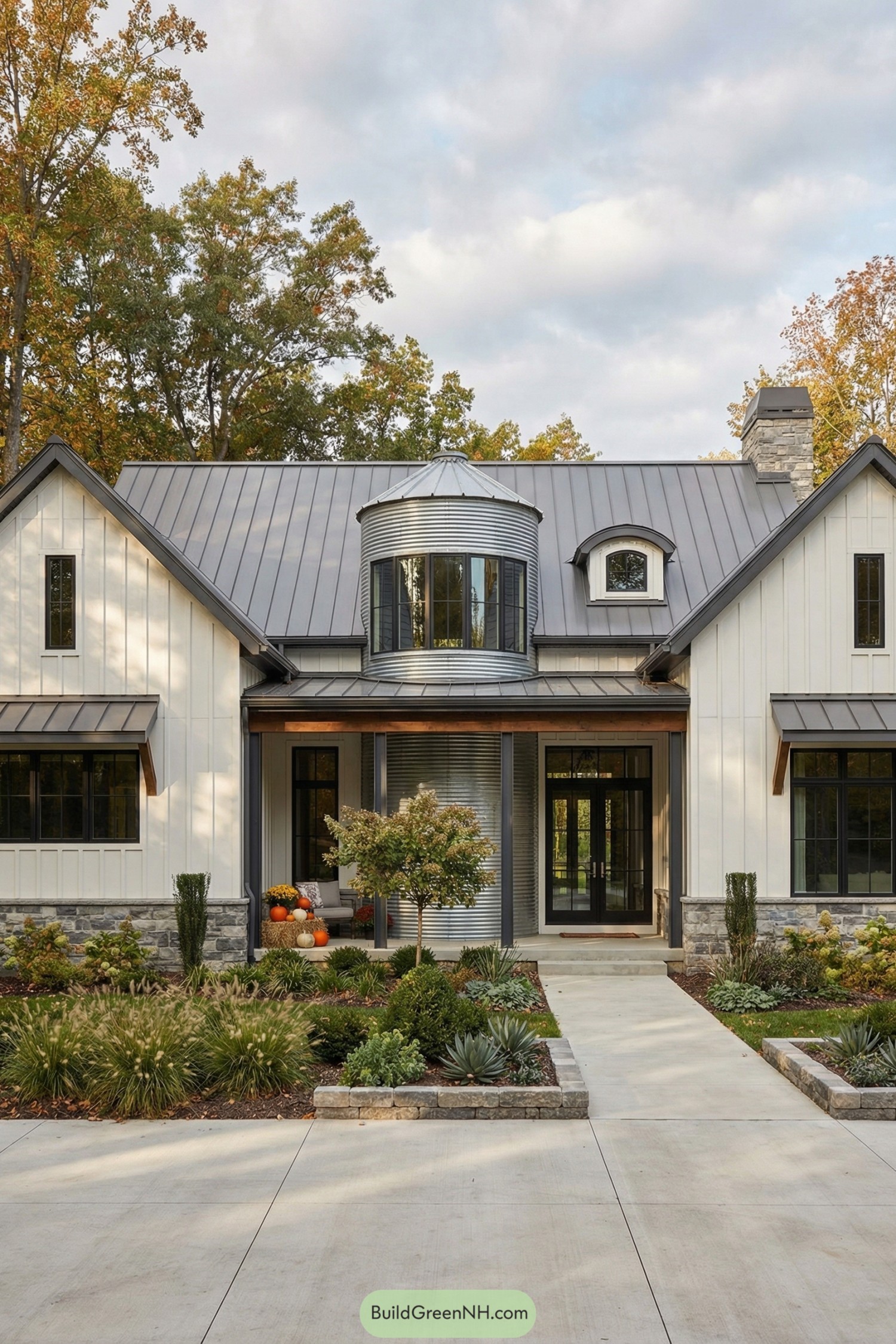 Modern farmhouse with central metal silo entry and lush front garden