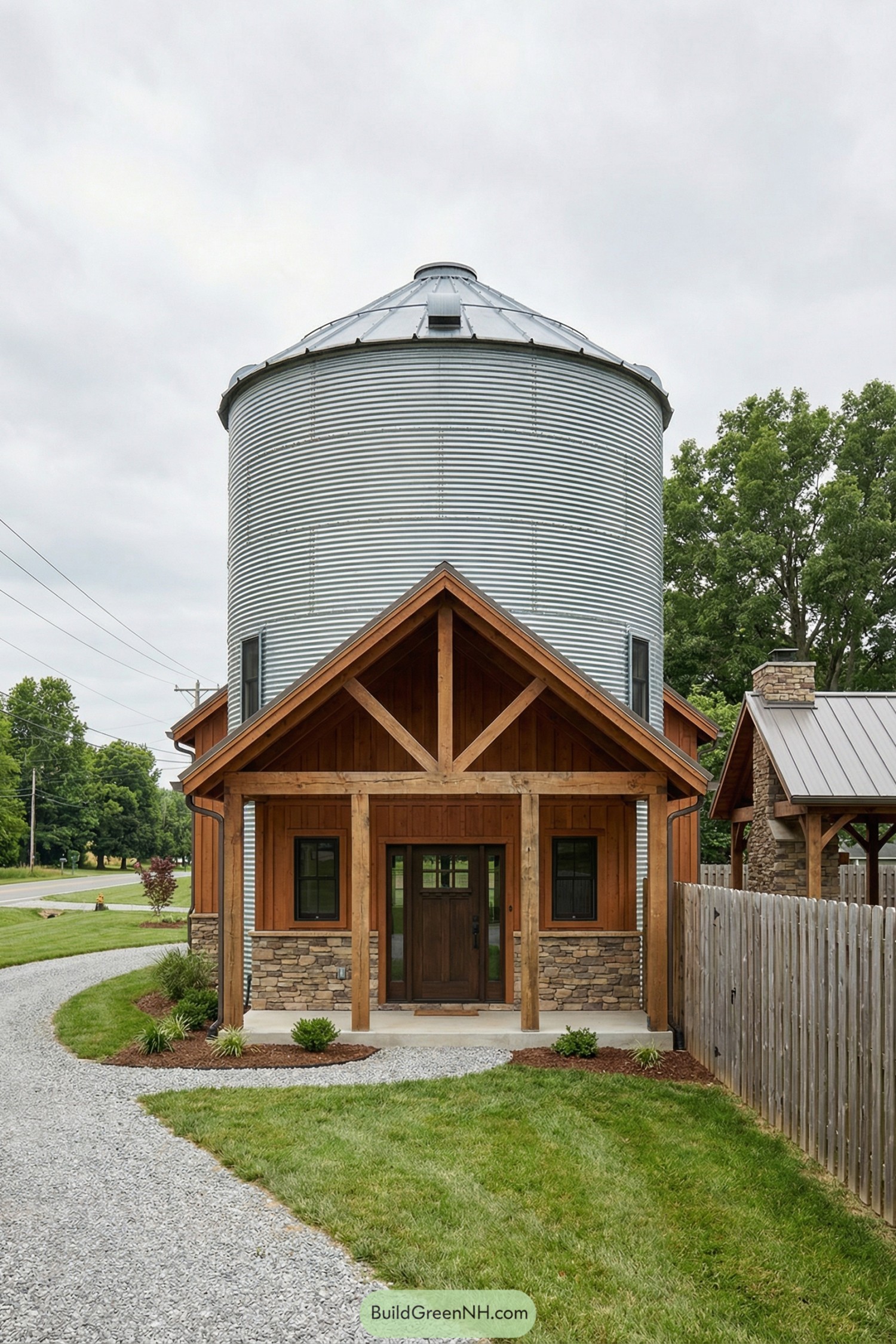 Modern silo house with corrugated metal tower and rustic timber front porch