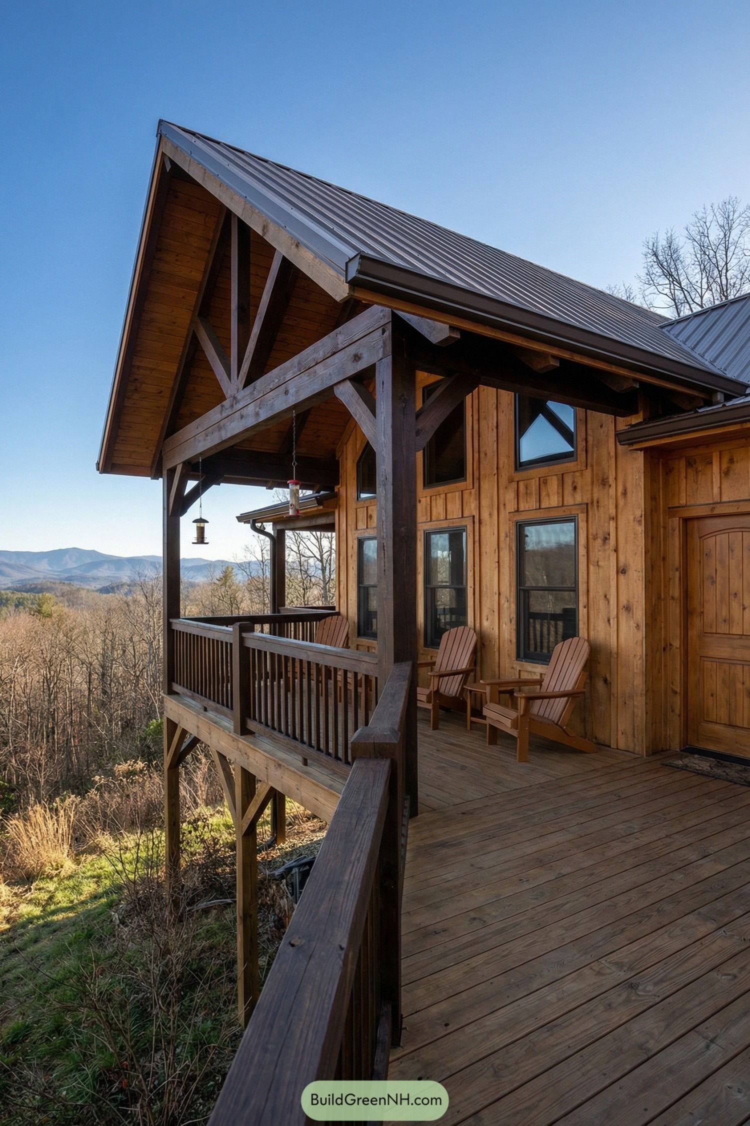 Wooden mountainside cabin with covered deck and chairs overlooking distant peaks