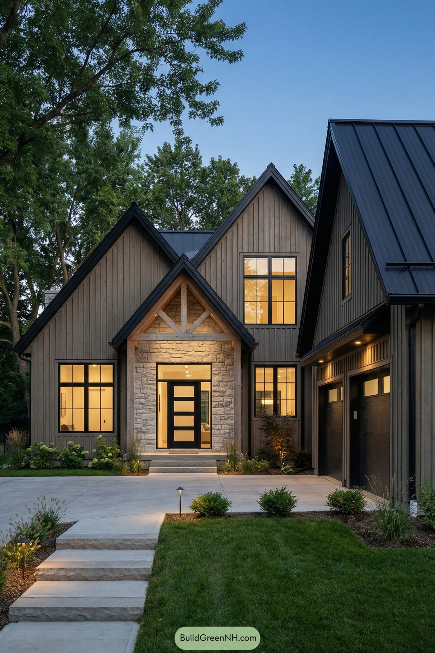 Modern Scandinavian house with tall gables stone entry and warm window lighting at dusk