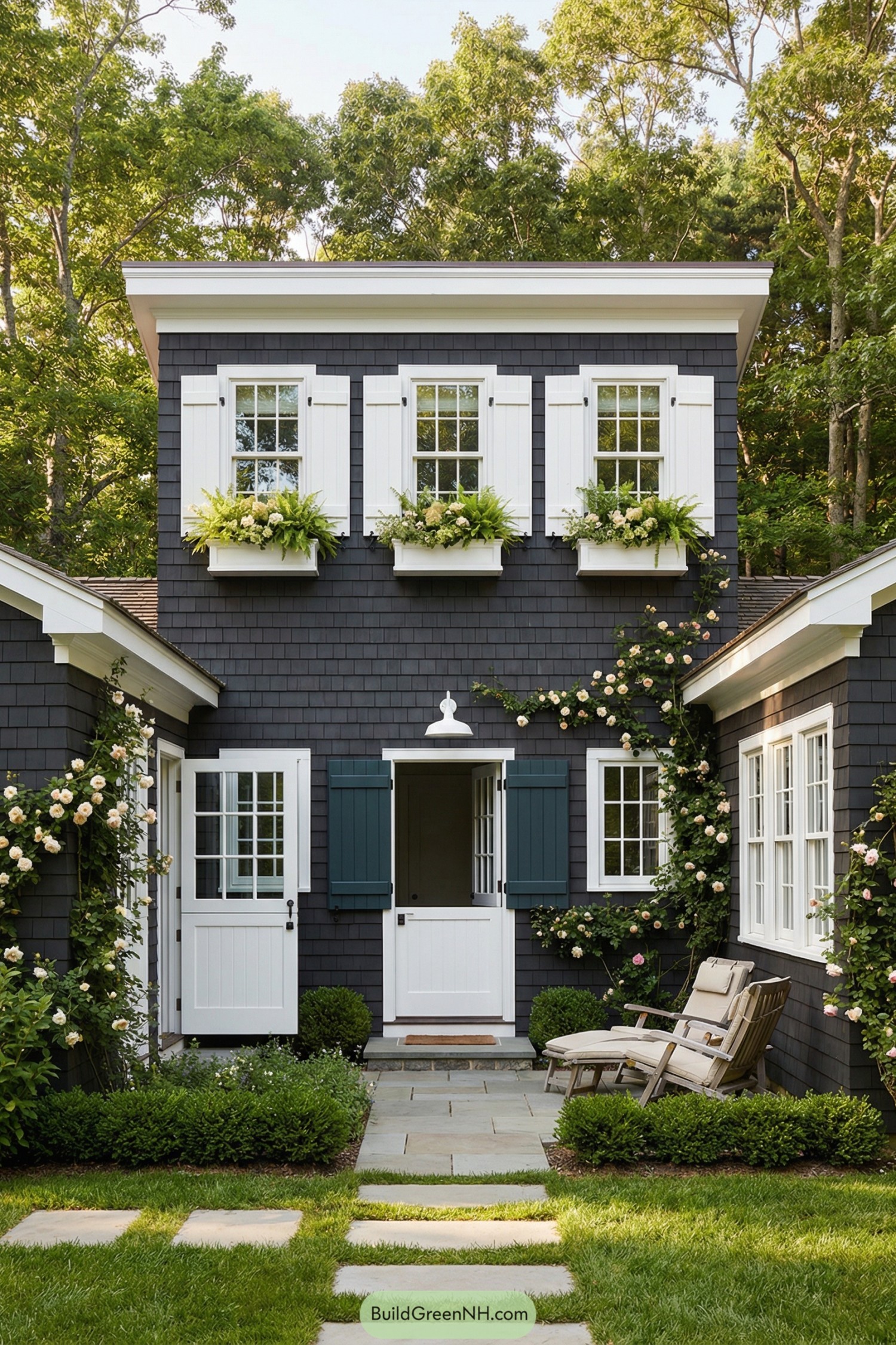 Dark shingle cottage with white trim and lush window boxes