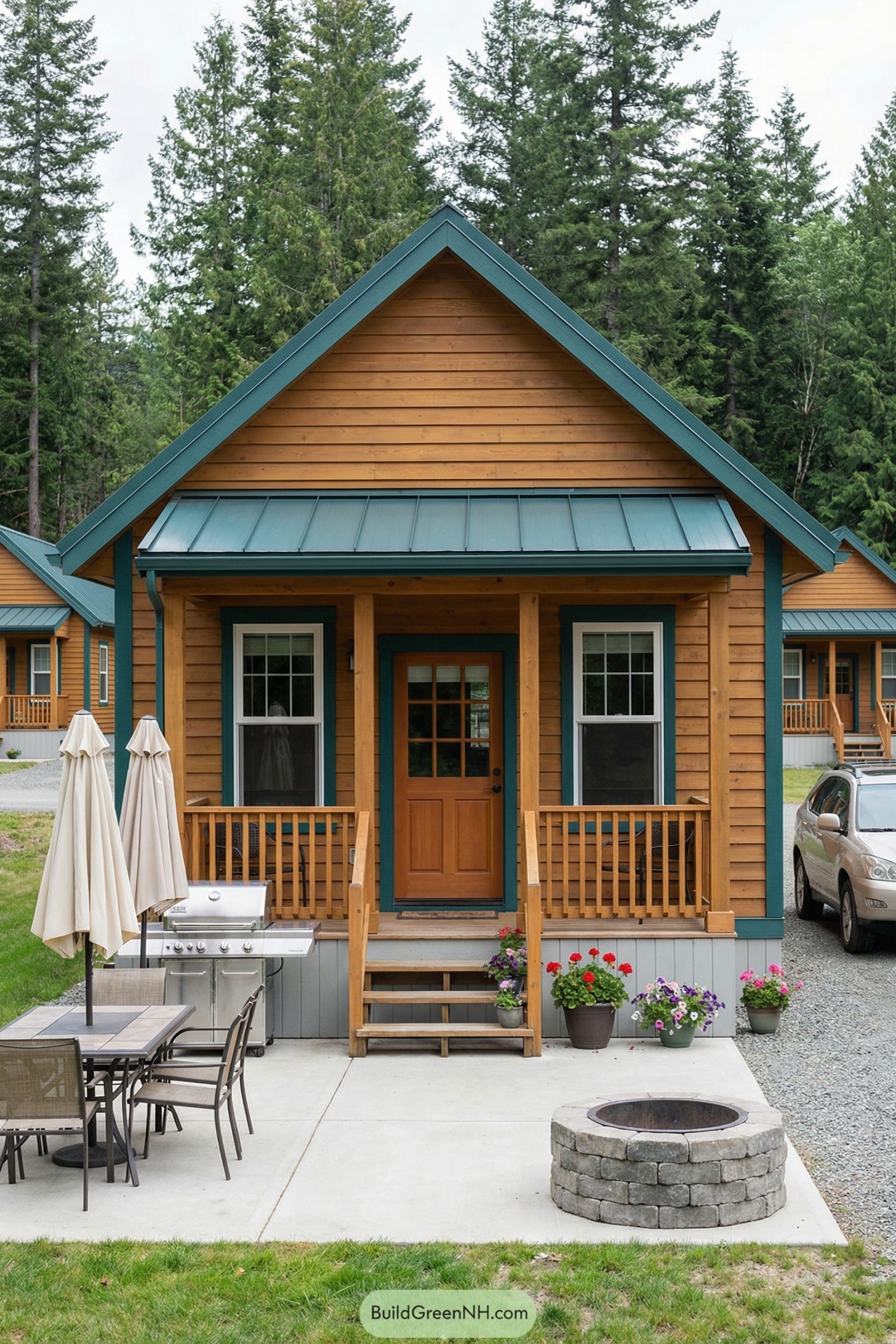 Small wood cabin with front porch, grill, and fire pit in a forest setting